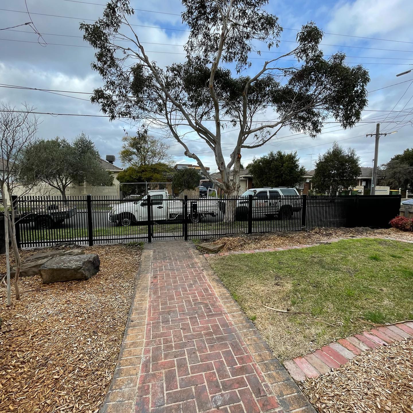 Stunning Satin Black Blade Style Fence with Chrome Accessories in Northcote 6 Residential area showcasing new blade style fence