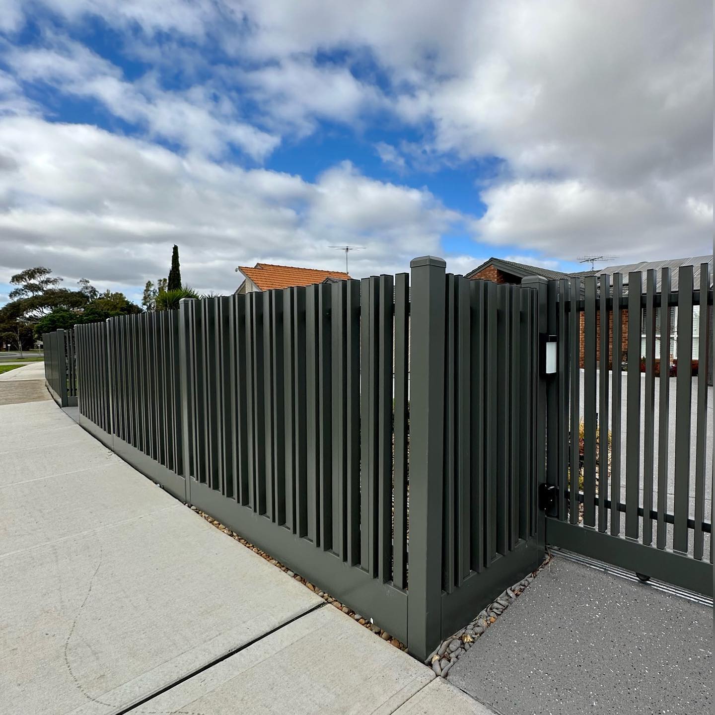 Pedestrian gate integrated into steel fence