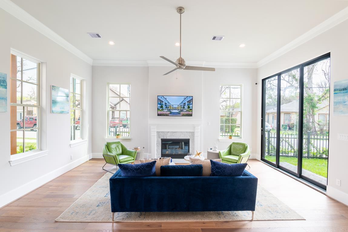 Eastwood Green Living Room with Fireplace and Wall of Glass