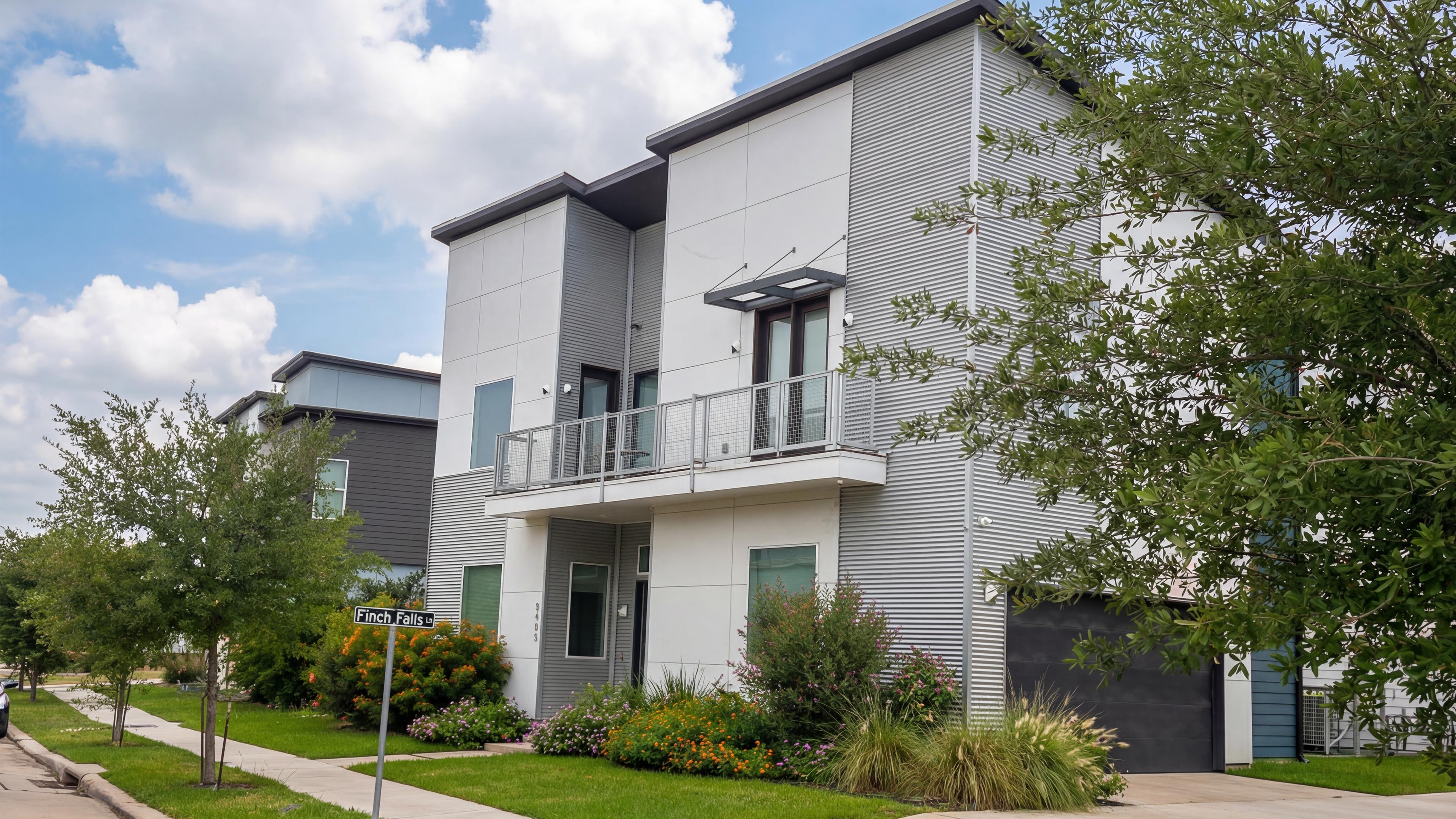 Avondale townhome exterior with balcony private driveway and garage