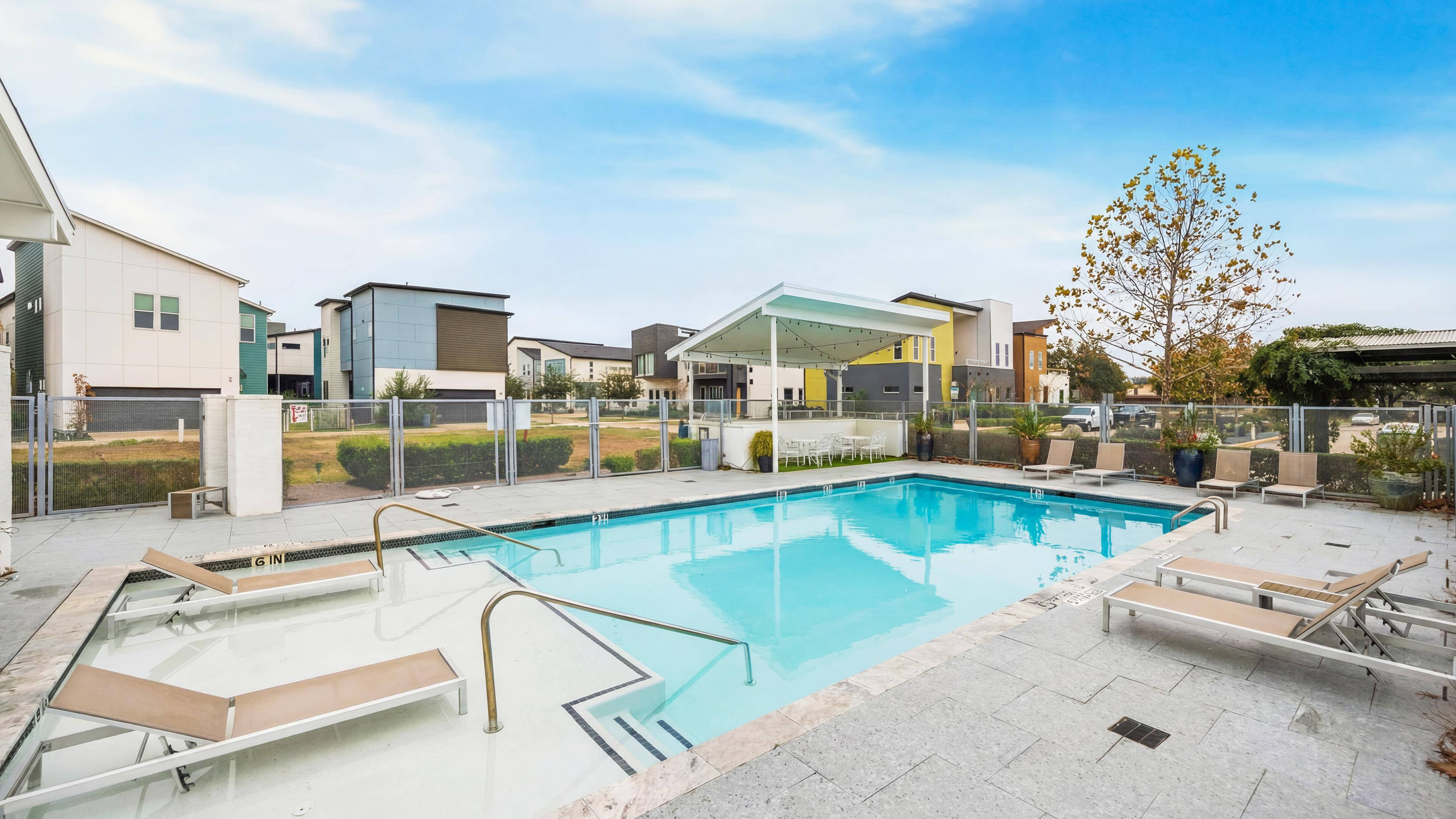 Avondale community pool with lounge chairs and shaded seating