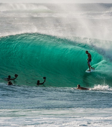 surfer getting barrelled