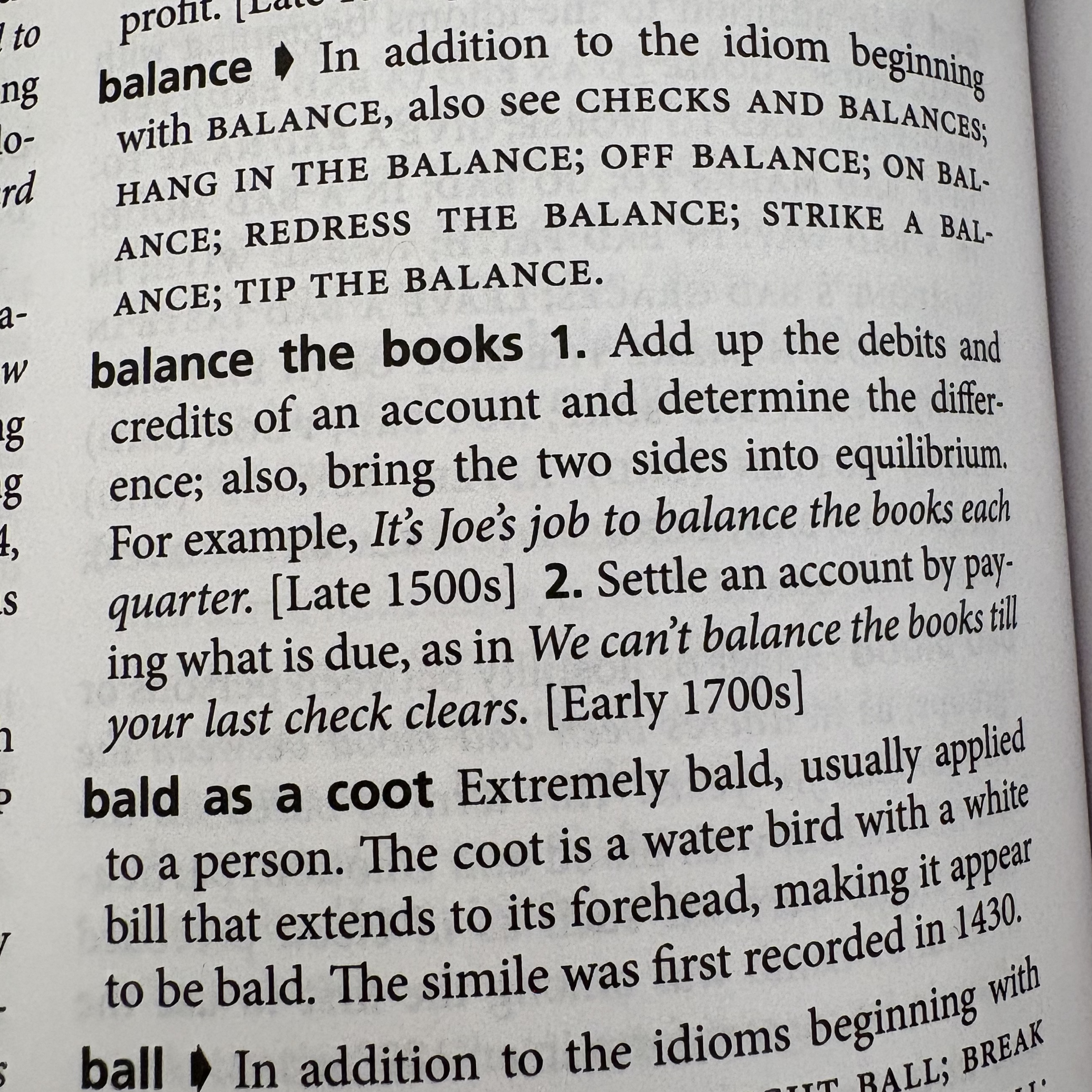 Picture of the inside of The American Heritage Dictionary of Idioms 2nd Edition for the entry 'Balance the Books'