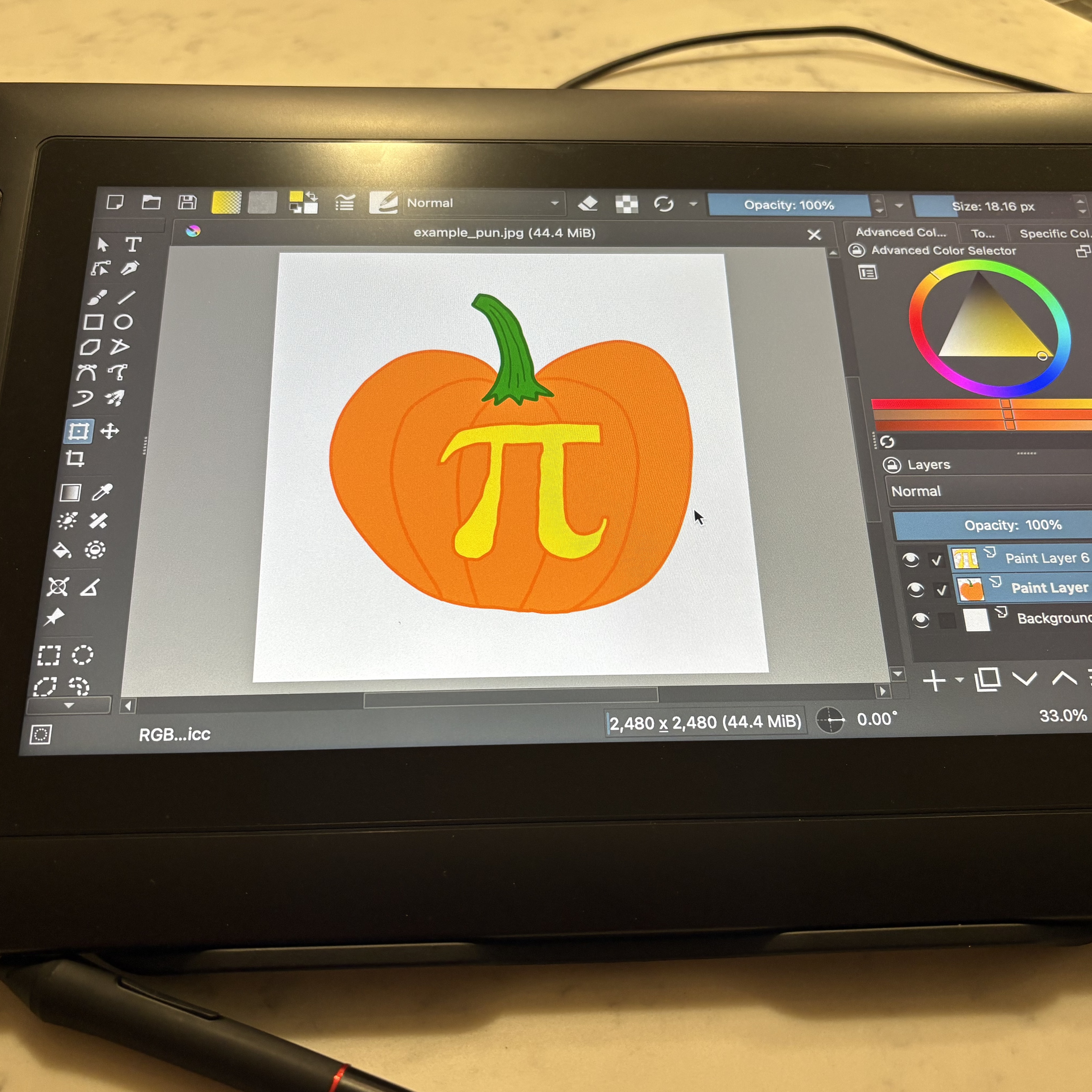 Picture of Krita program open on drawing pad with drawn pumpkin with pi symbol carved into it showing