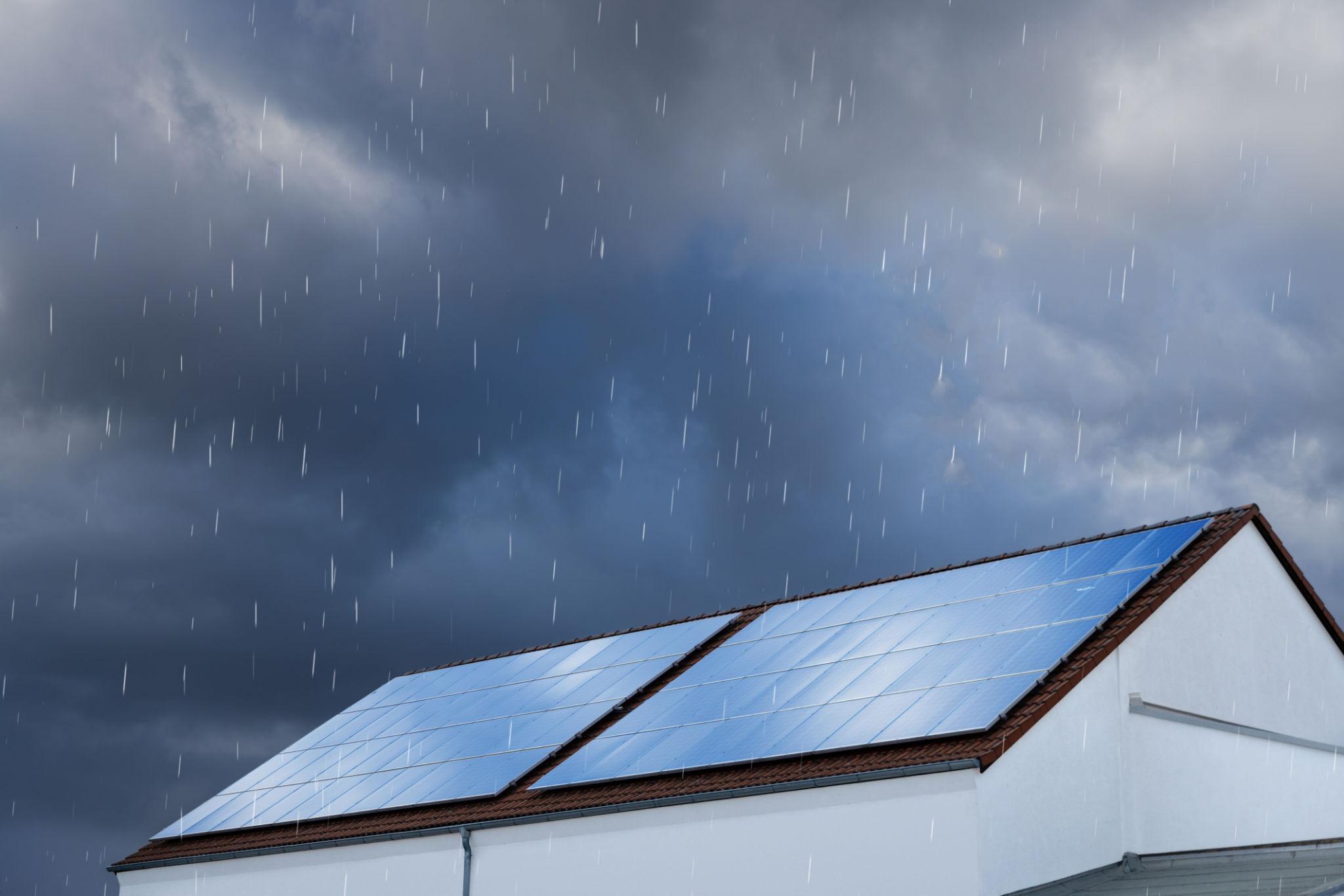 Solar panels on house roof in rain