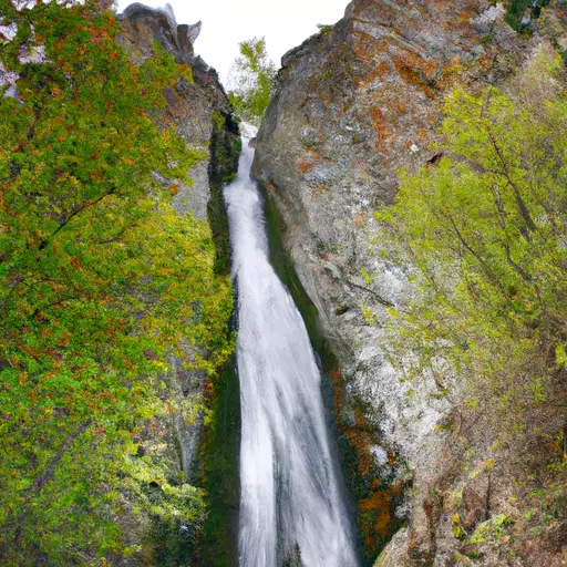 A picture of a tall waterfall cascading down a mountain