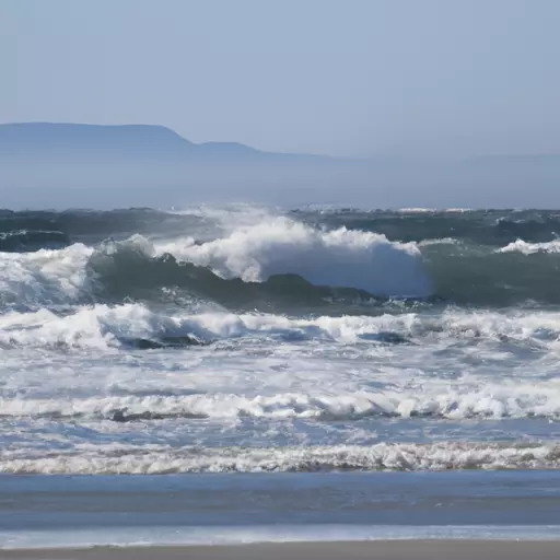 A picture of waves crashing against a beach