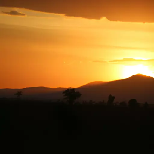 A picture of a beautiful African sunset with silhouettes of mountains in the background