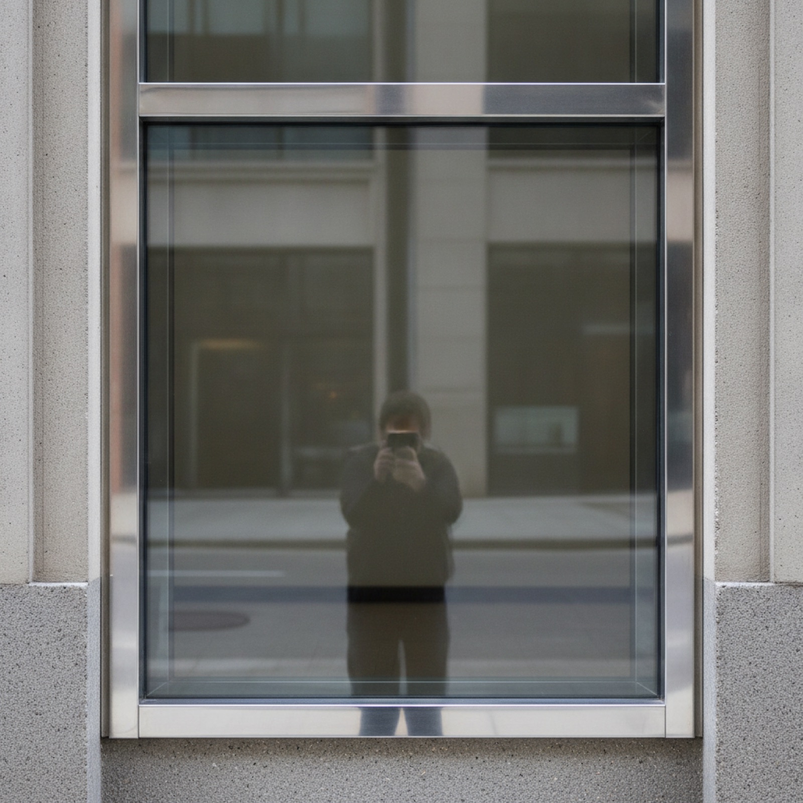 Center-set storefront detail showing symmetric glass positioning and balanced aluminum sightlines
