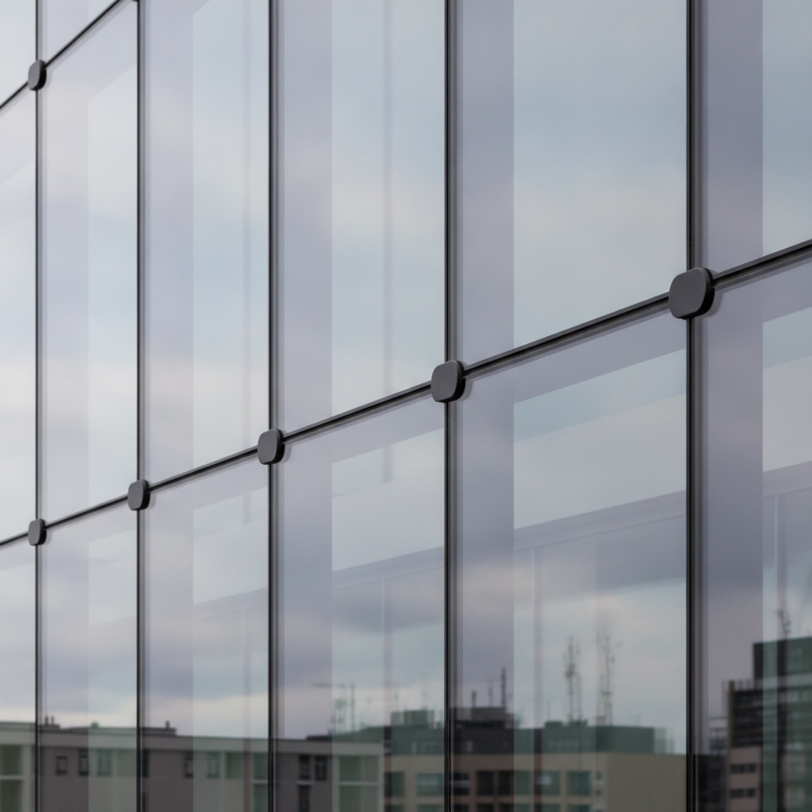 Flush-glazed storefront with minimal caps creating seamless glass plane appearance