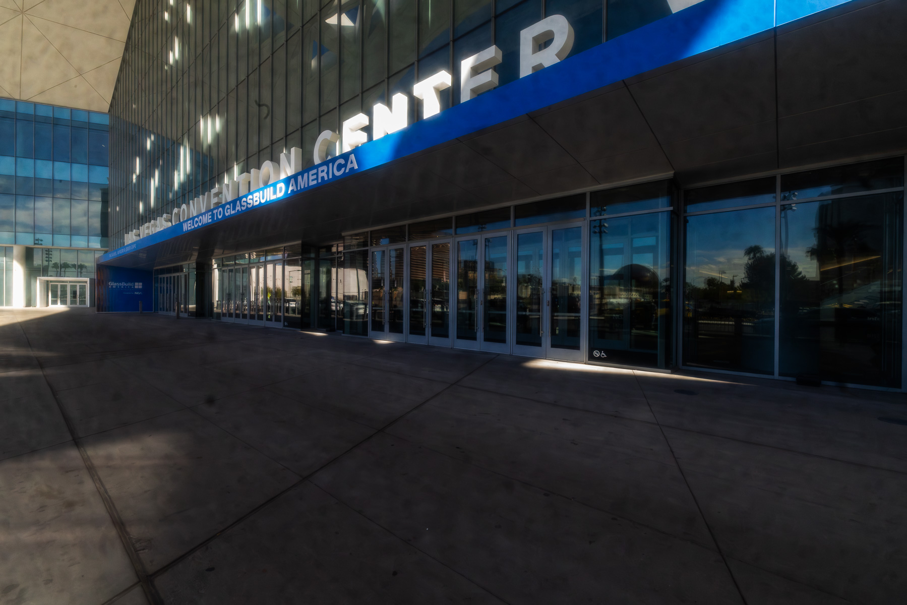 The exterior of the Las Vegas Convention Center West Hall entrance with "WELCOME TO GLASSBUILD AMERICA" signage.
