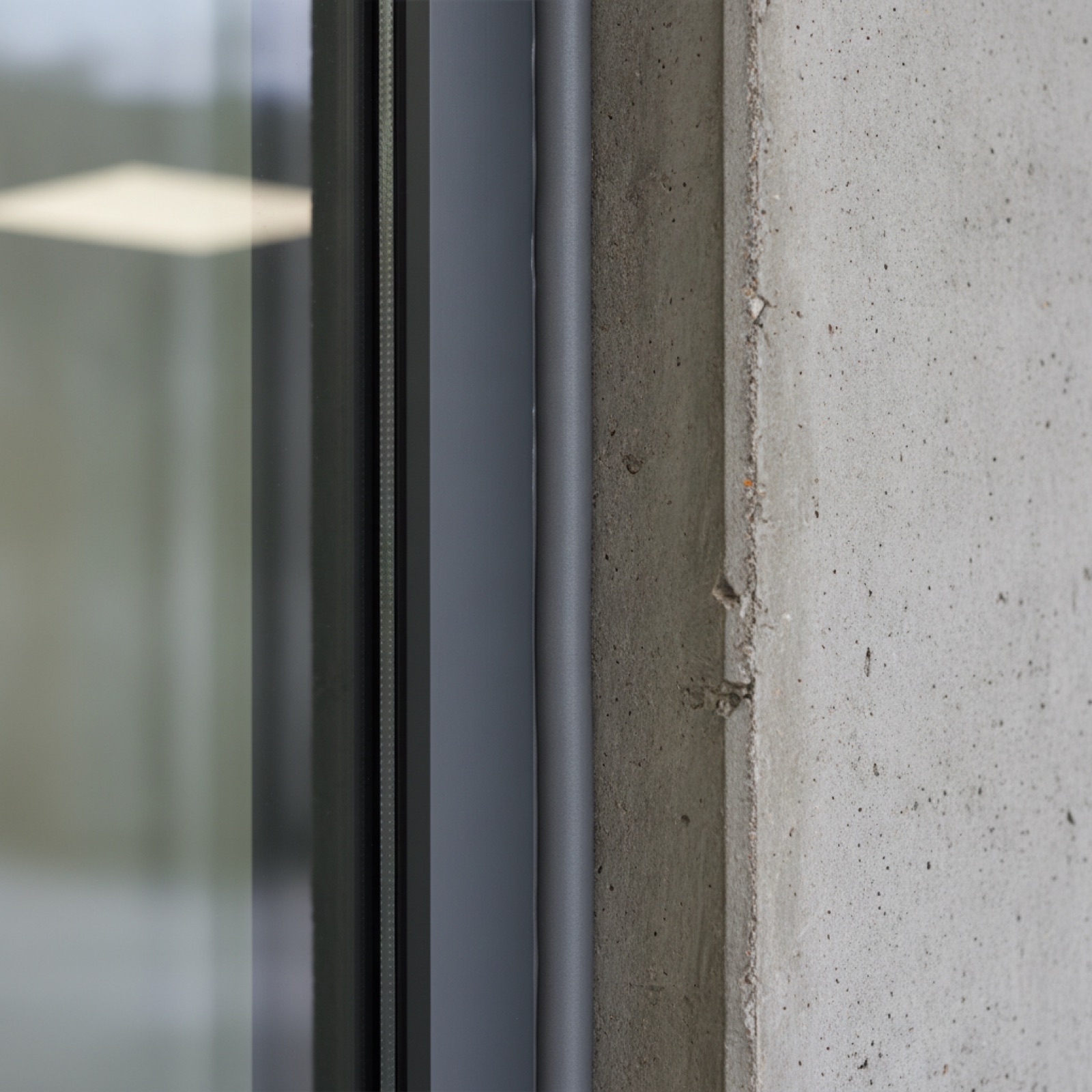Perimeter sealant joint between storefront framing and building wall structure