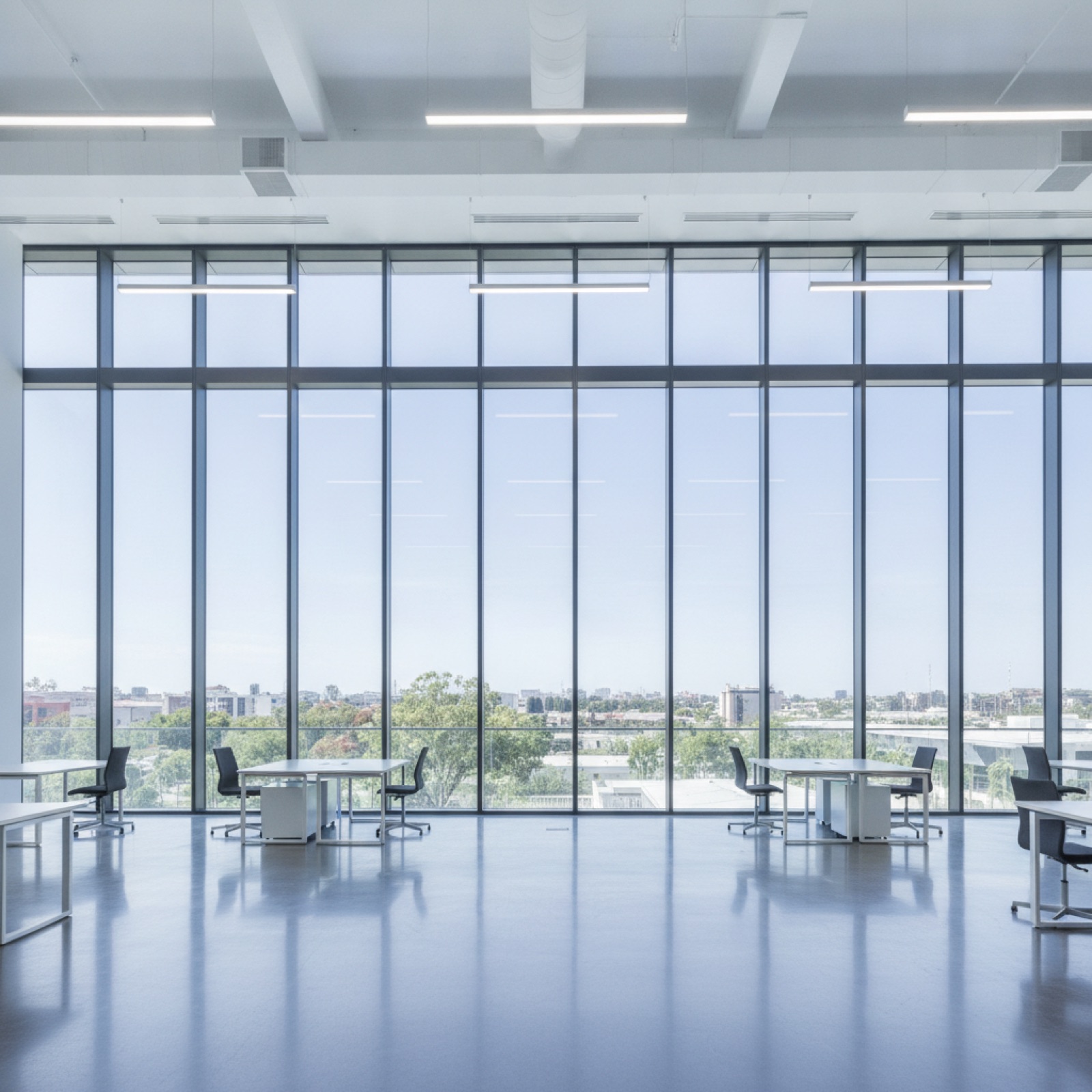 Interior commercial space illuminated by thermally efficient low-E glazing system with thermal-break framing
