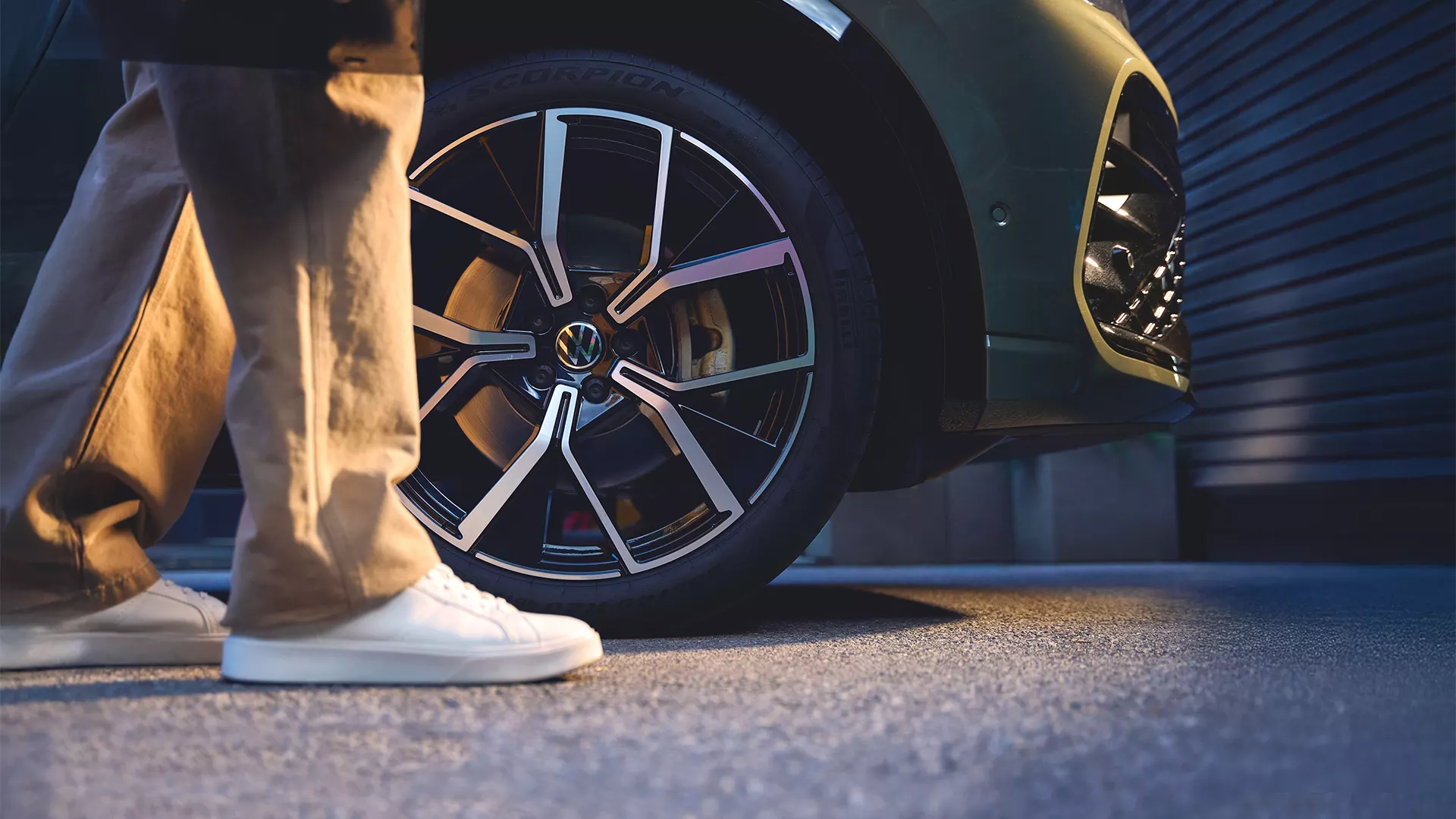 Ruota moderna di un'auto Volkswagen, con una persona accanto.