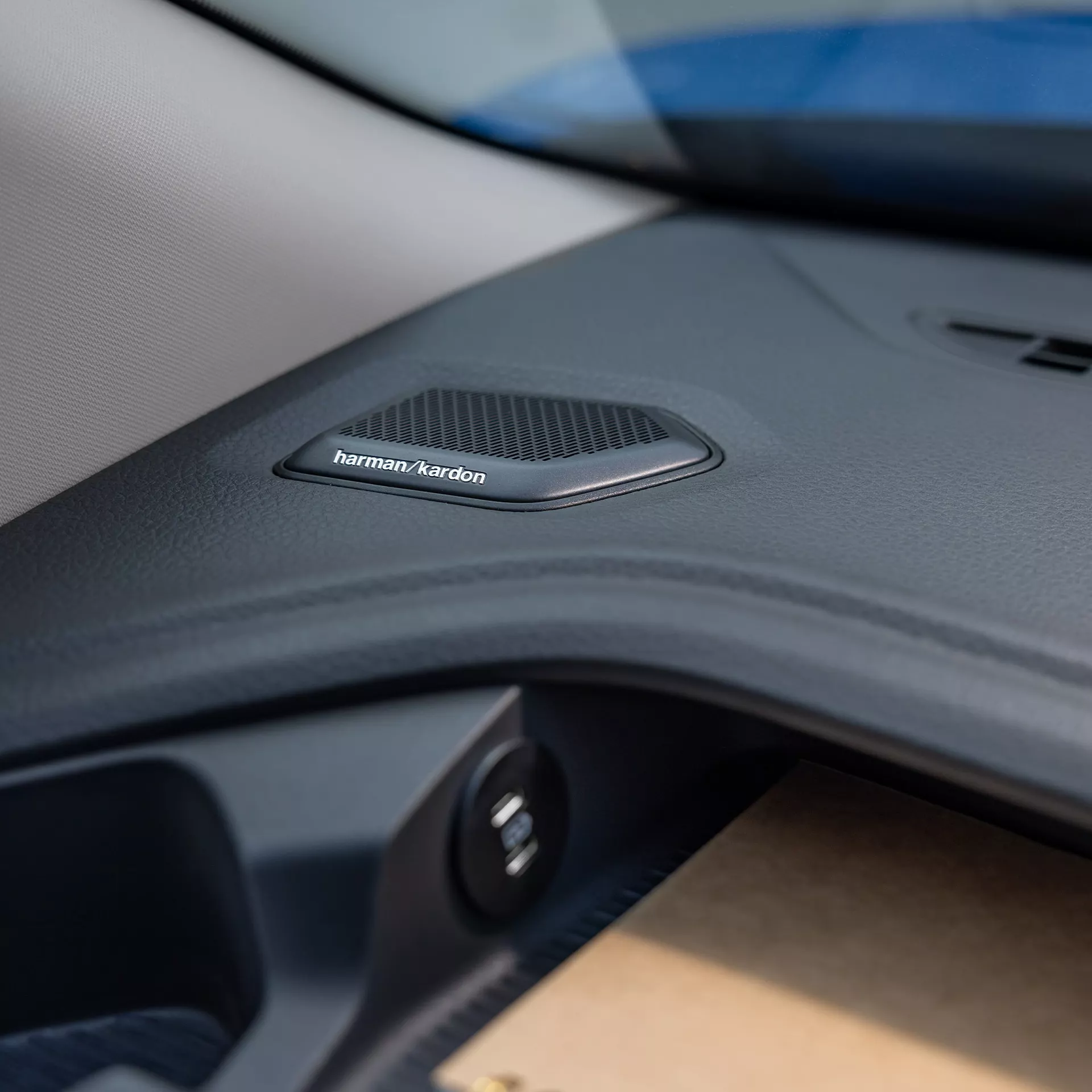 Un dettaglio dell'interno di un'auto, con l'altoparlante Harman Kardon.
