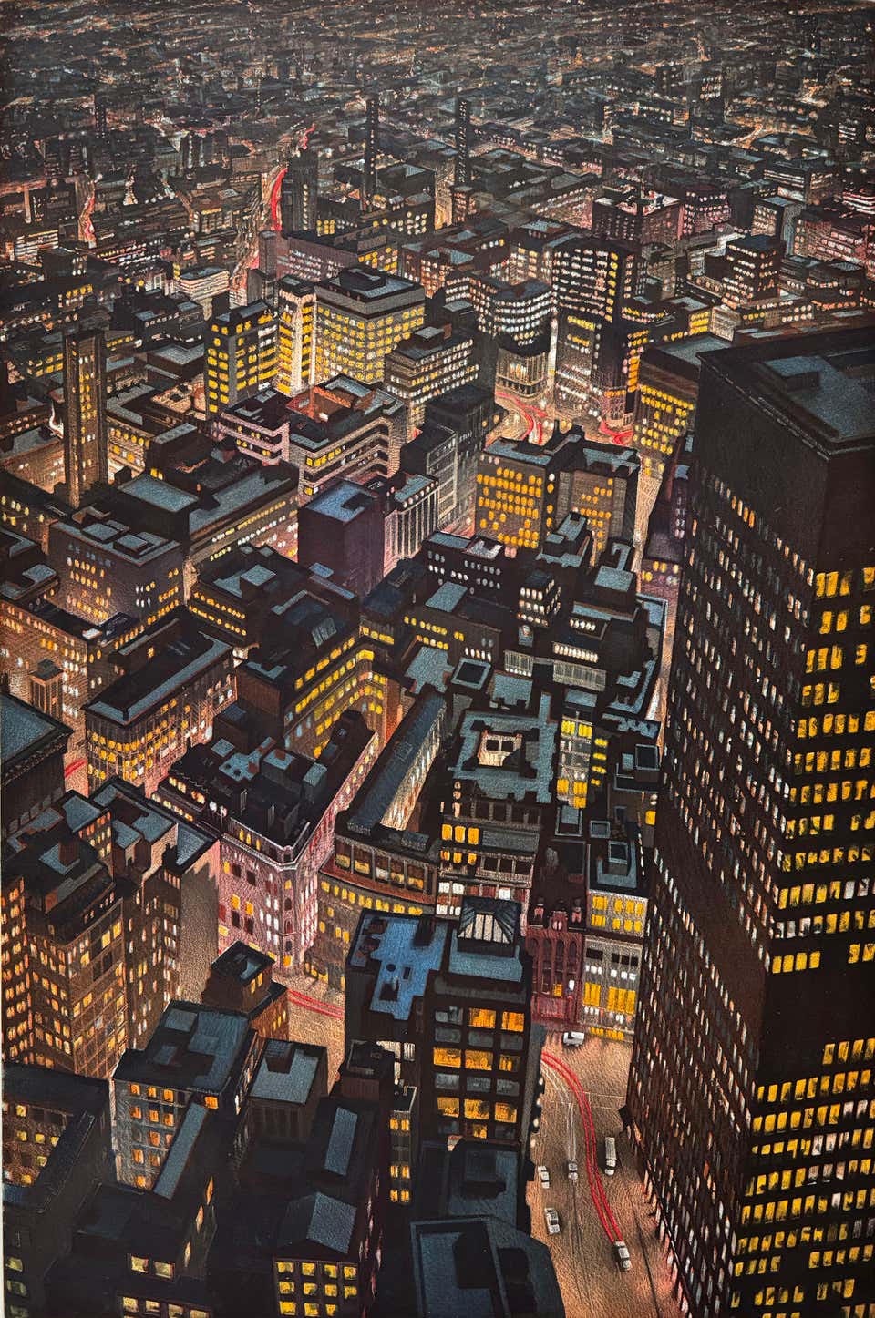 A high aerial view of a dense city at night, with illuminated yellow windows, dark rooftops and red trails of traffic