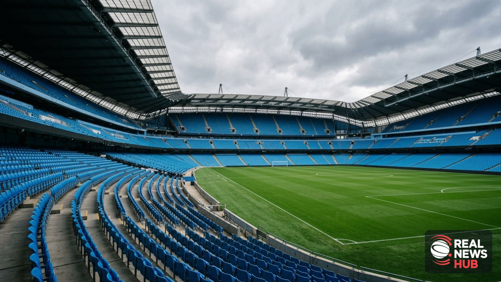 An empty modern football stadium with blue seats viewed from the stands on an overcast day.