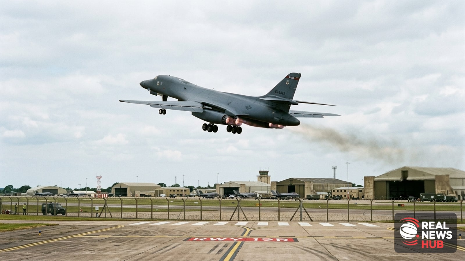 A military bomber takes off from an airbase runway under an overcast sky.