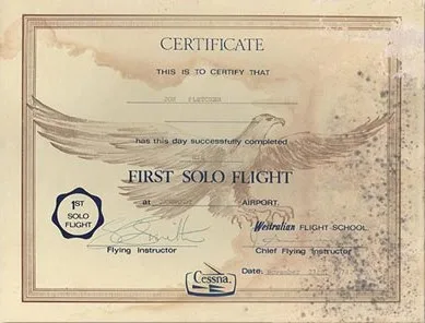 Stained certificate with brown water rings and dark spotting across the right side