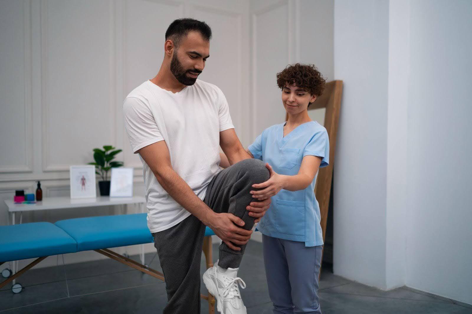 Doctor guiding a person after knee surgery for exercises.