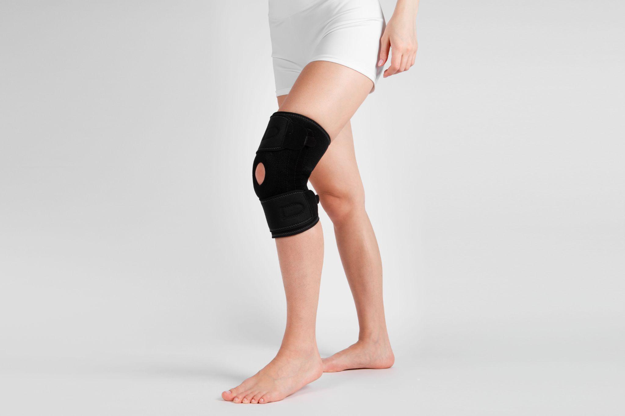 A woman’s bandaged knee from injury.