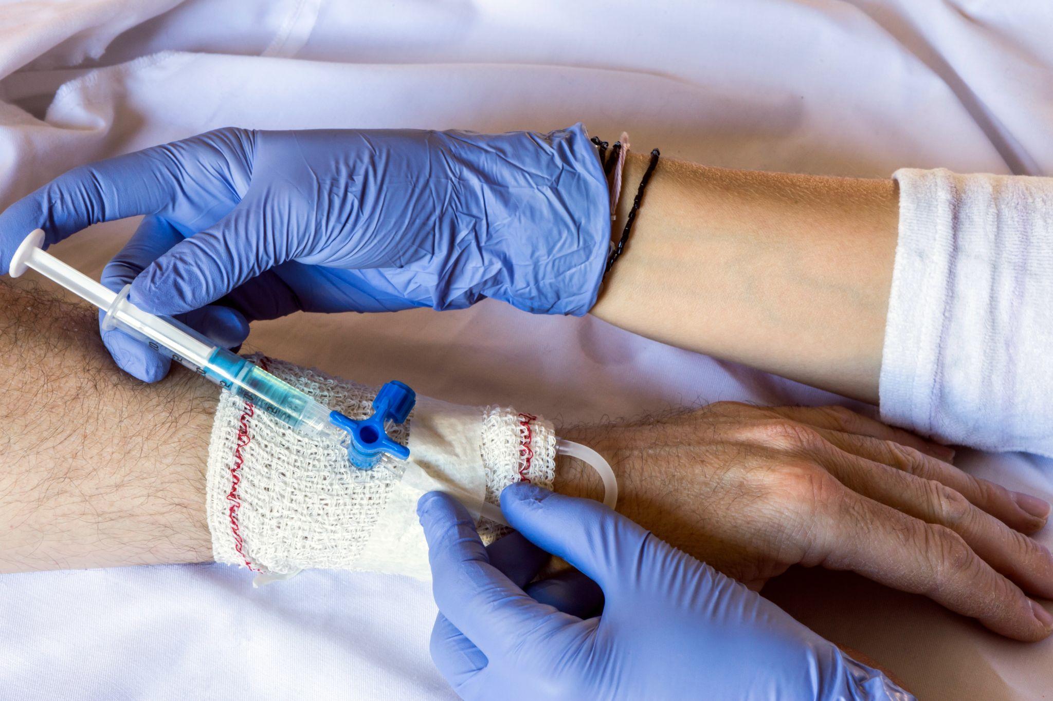 A doctor giving glucose to a patient.