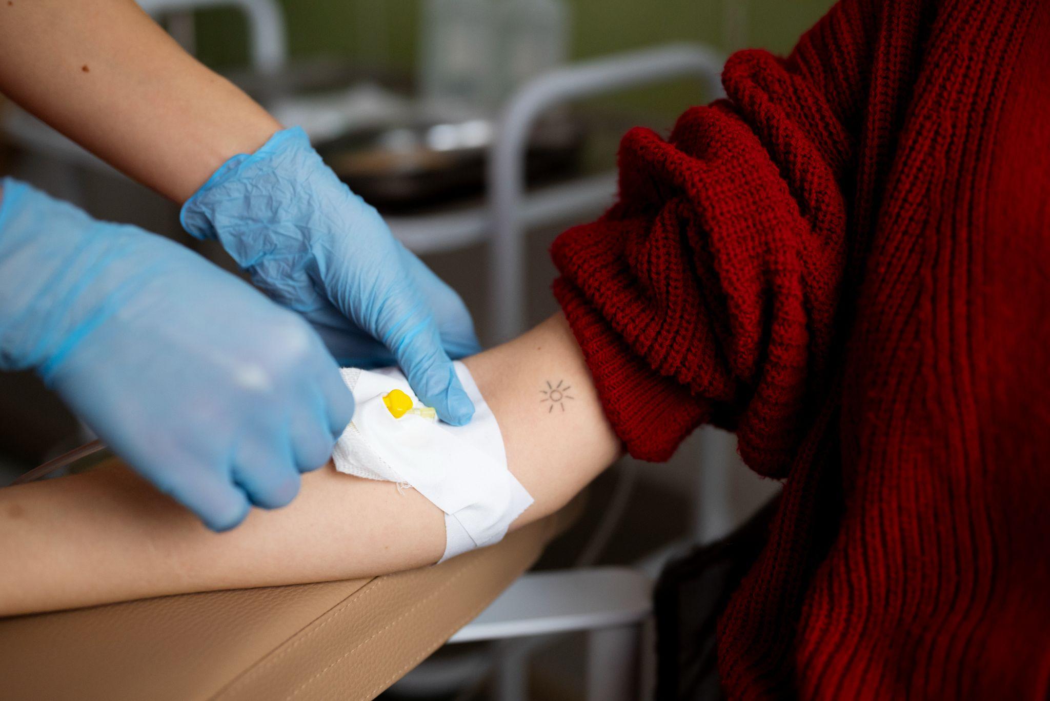 A doctor taking blood for checking.