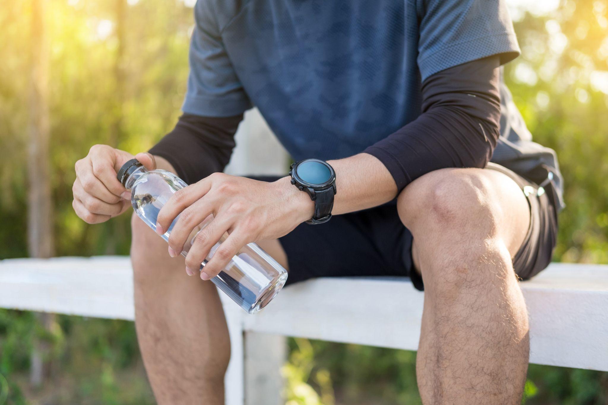 A man holding water bottle.