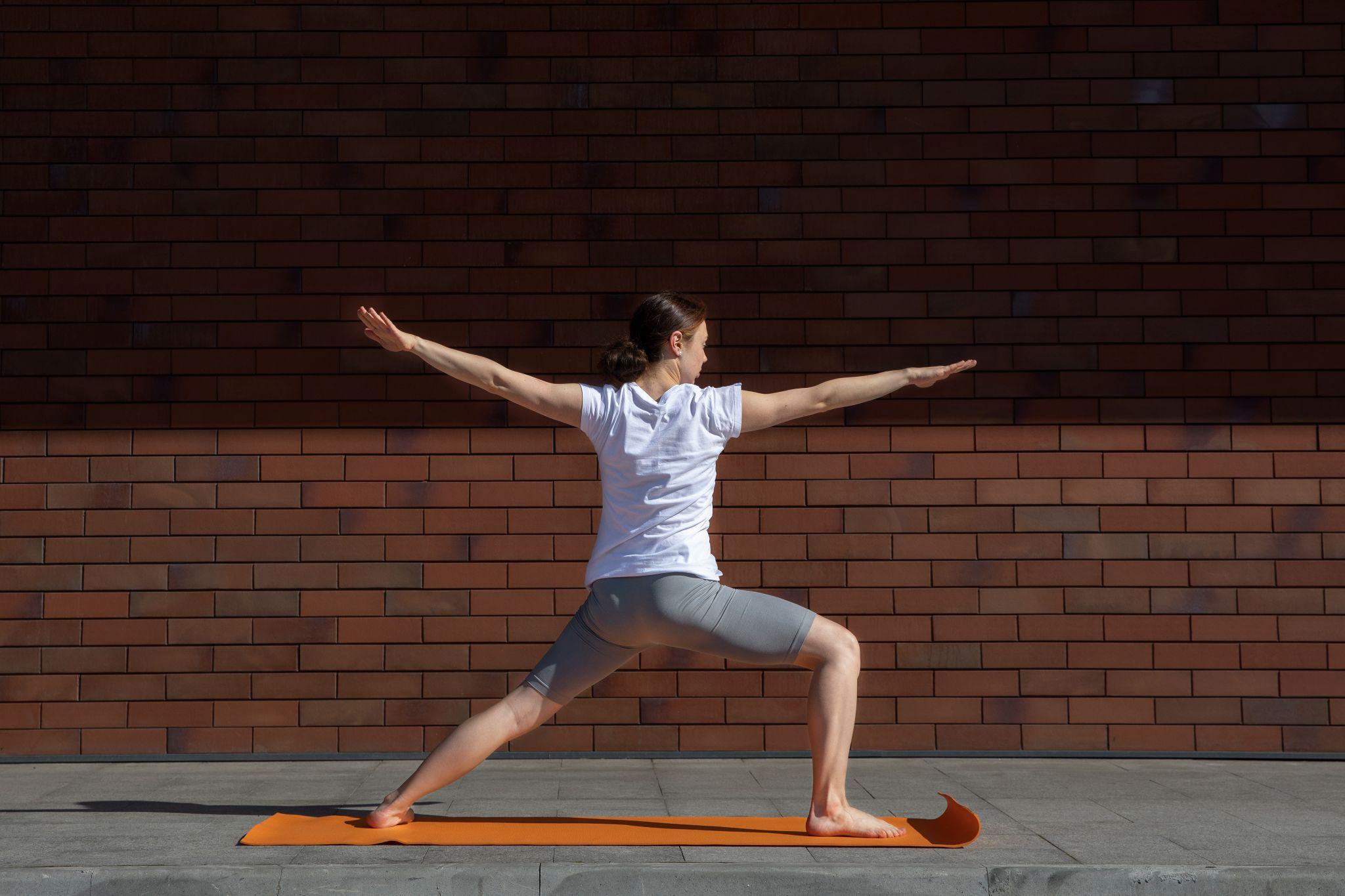 A woman doing yoga in sunlight.