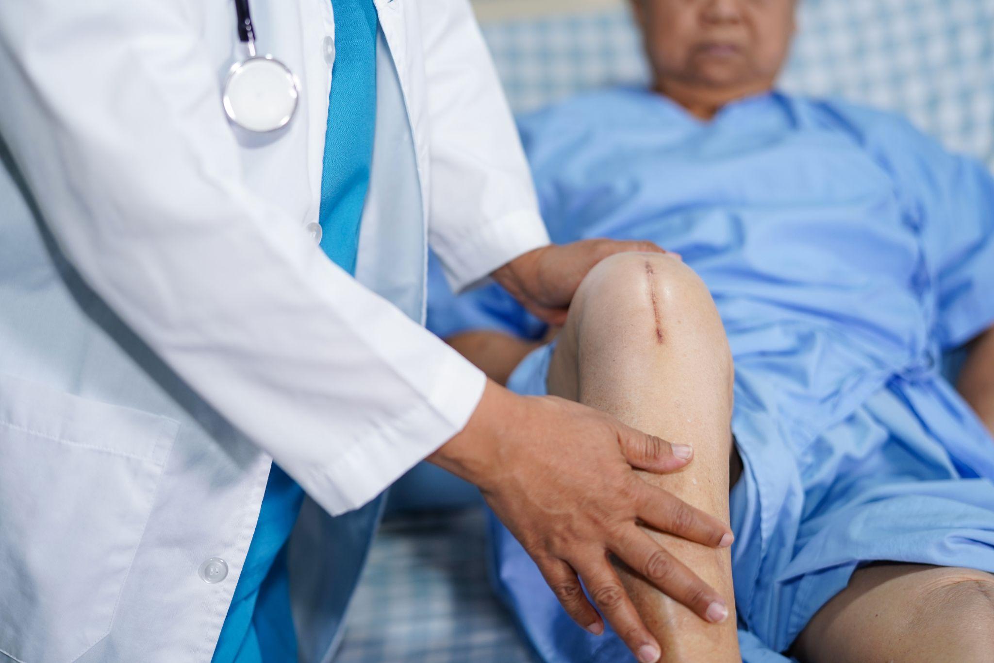 A doctor checking a patient’s knee.