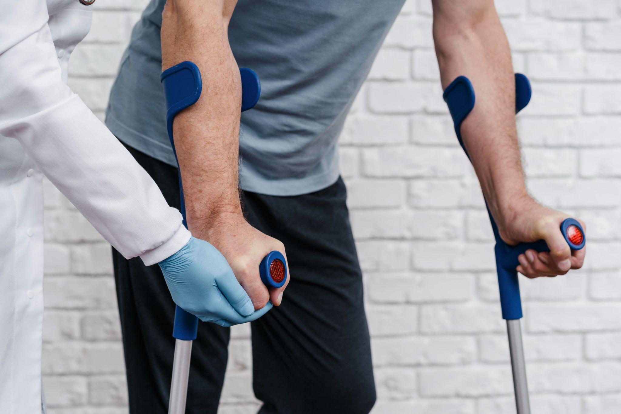 A doctor helping a person walk.