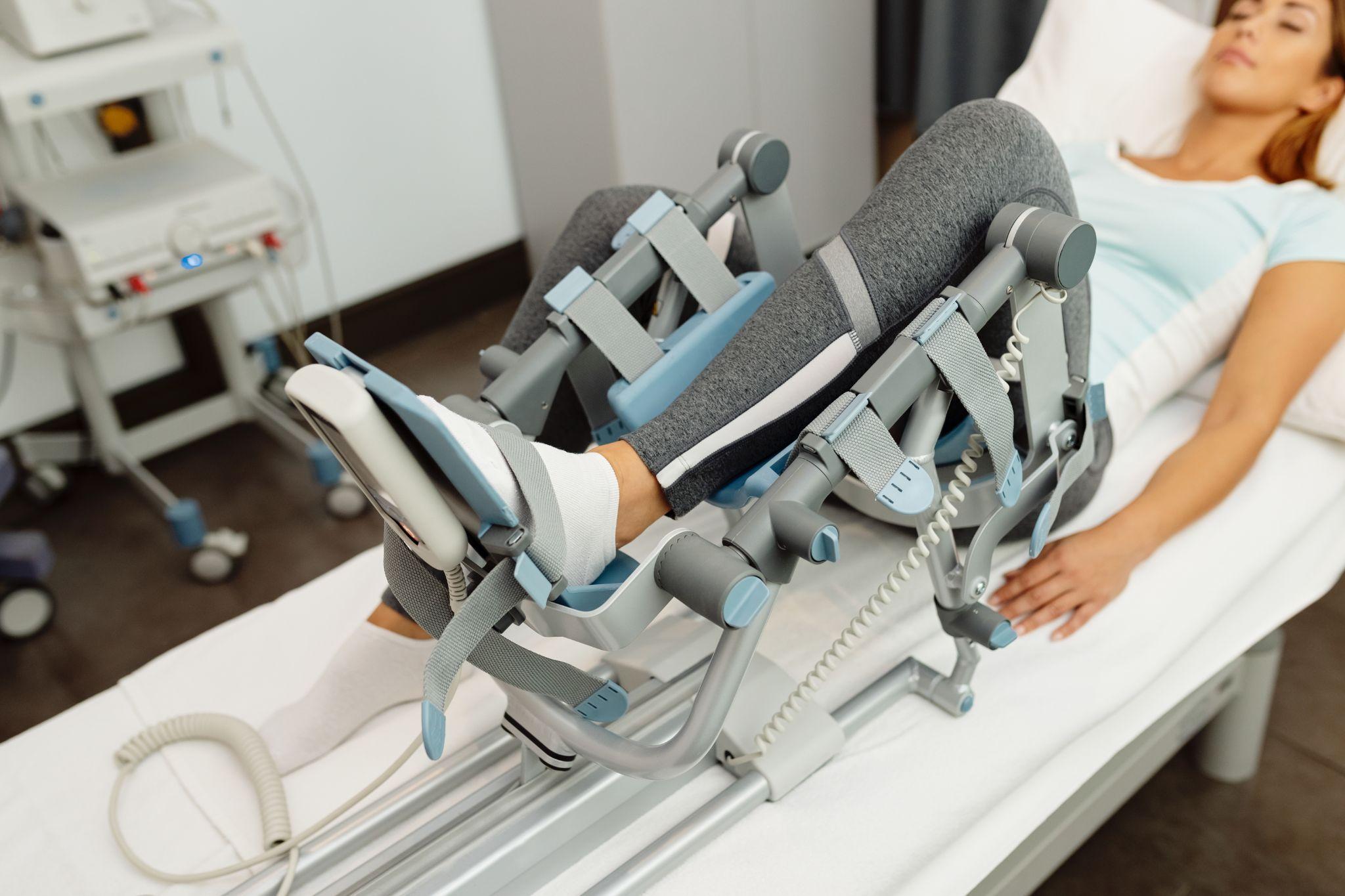 A woman using a CPM Machine.