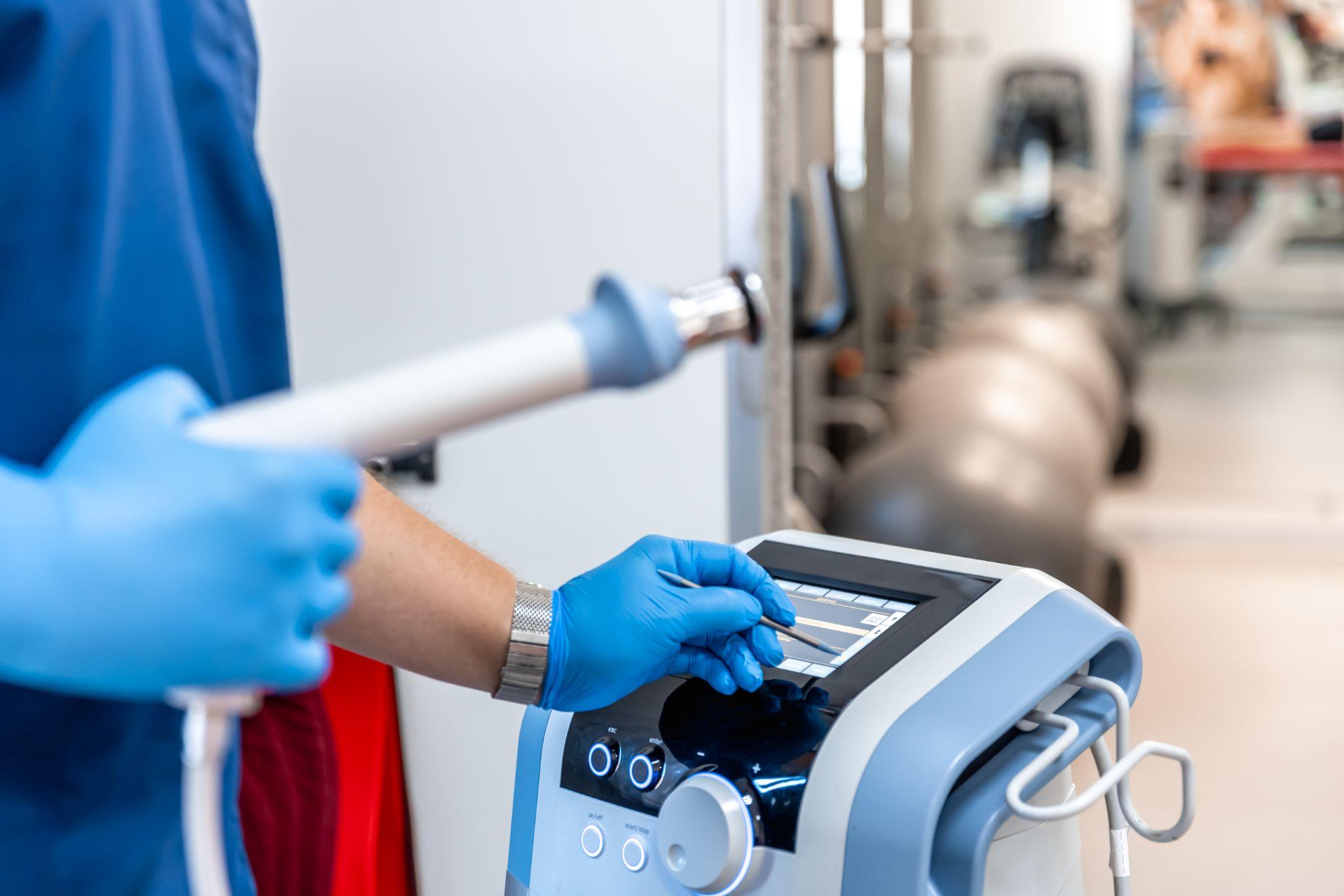 A doctor holding an open pipe of the CPM Machine.