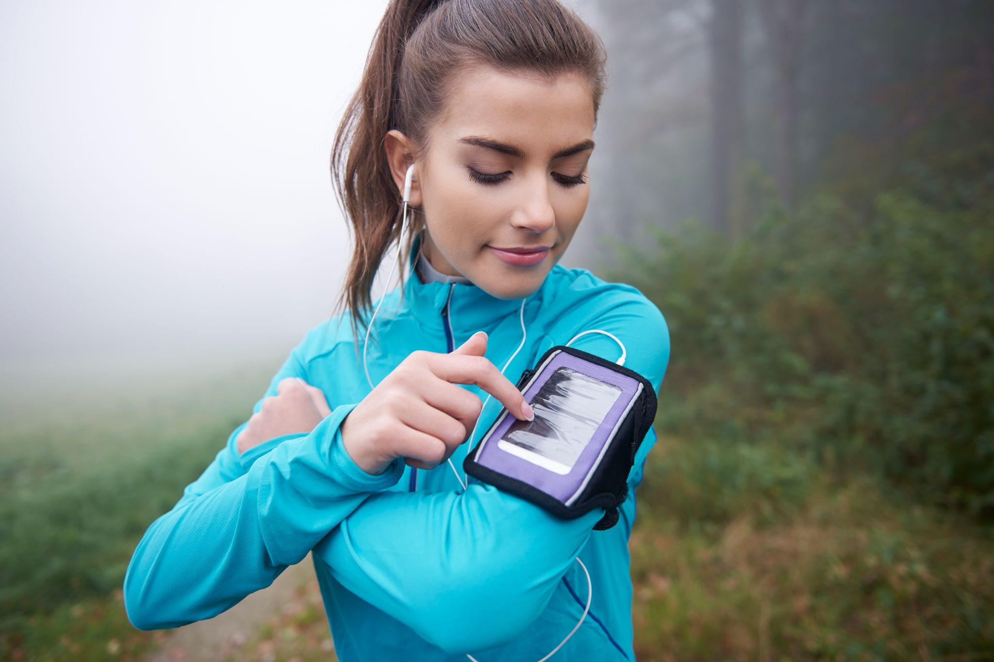 A woman wearing a tracker strap on her arms.
