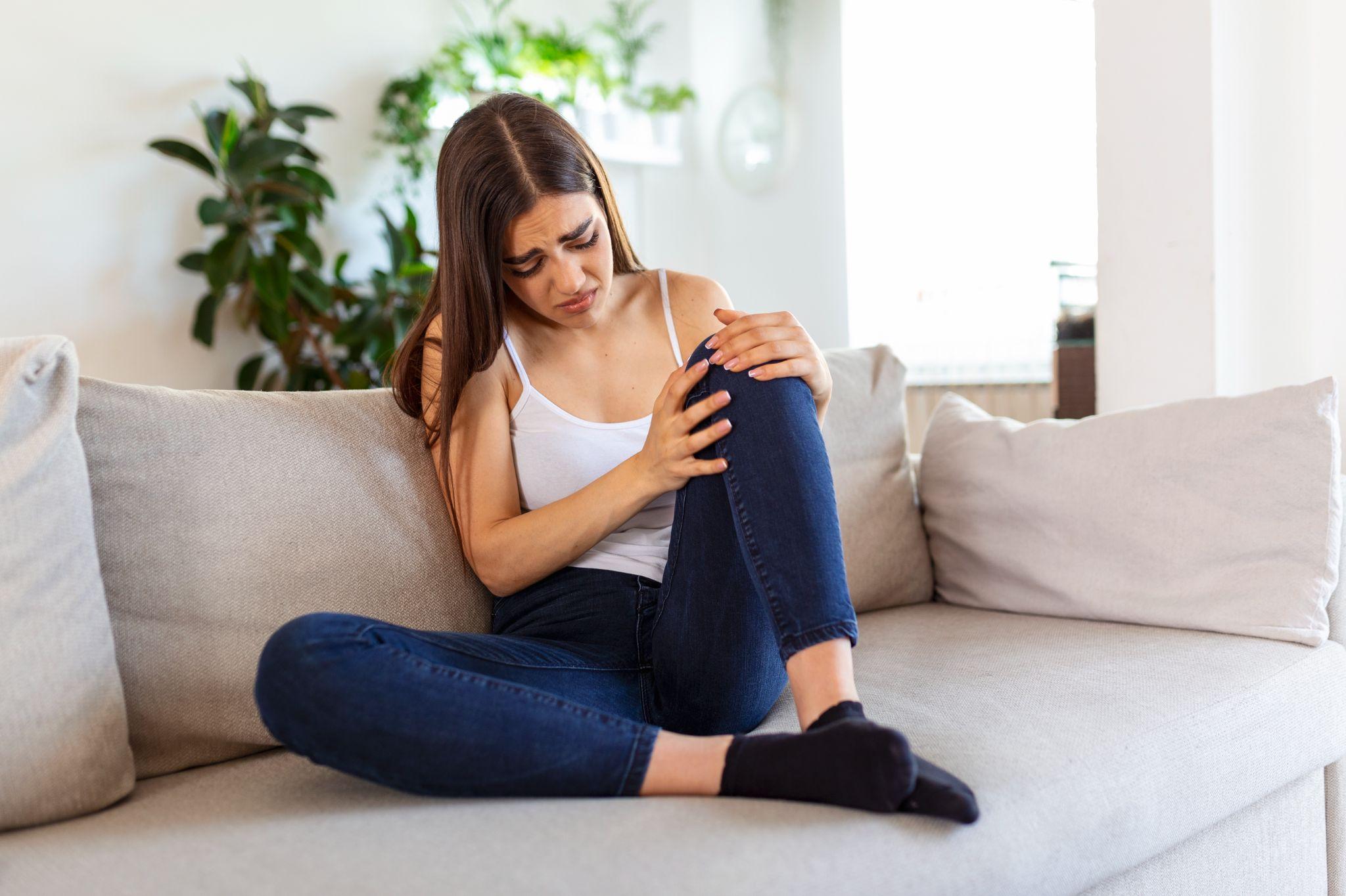 A woman holding her knee.