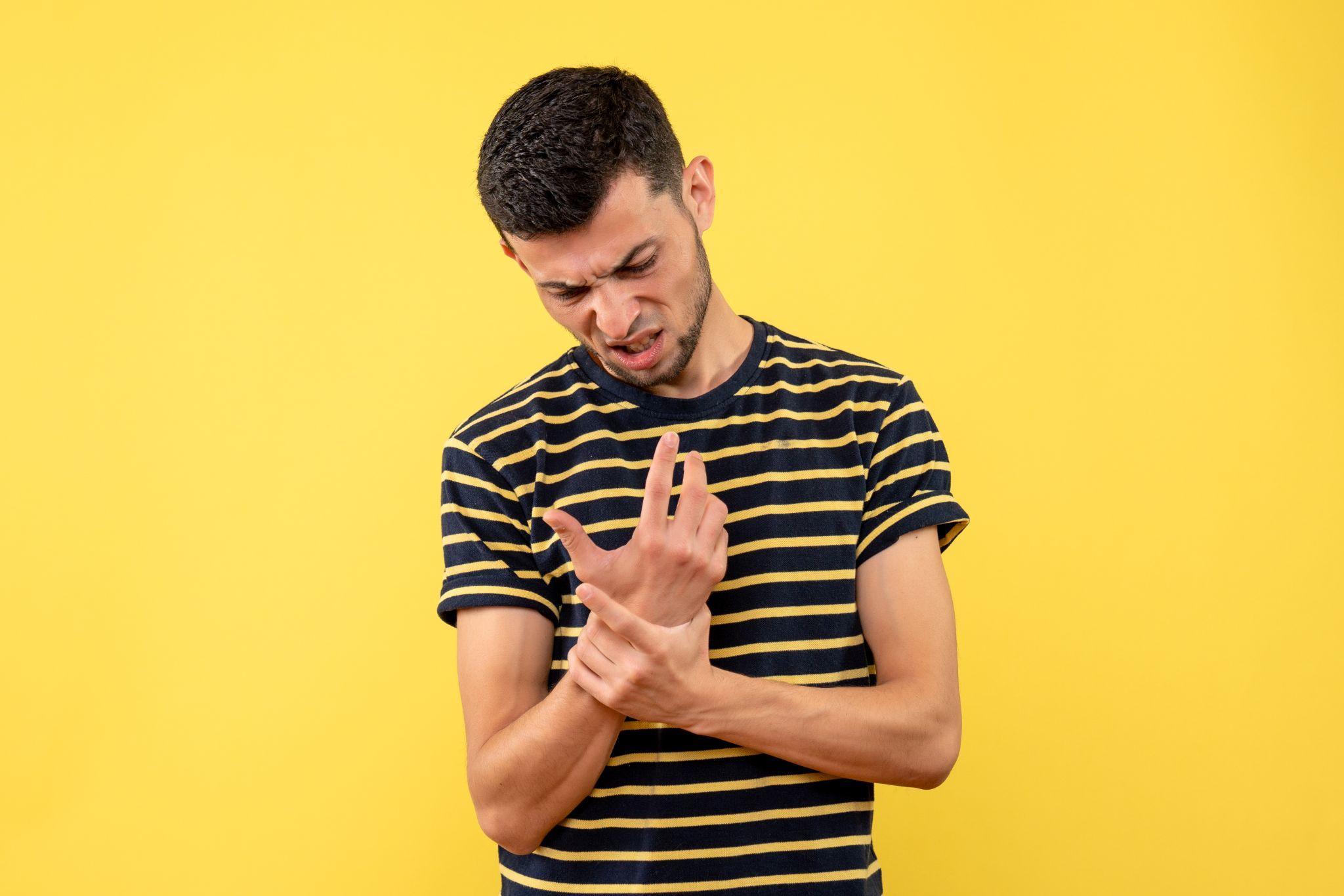 A man holding his wrist.