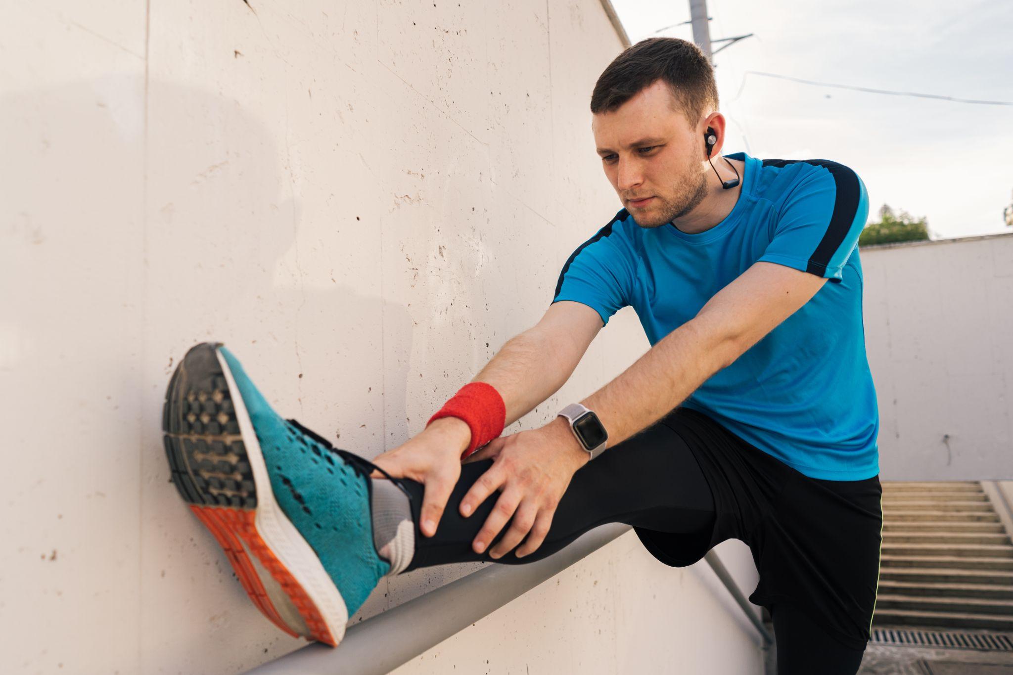 A man stretching his leg.