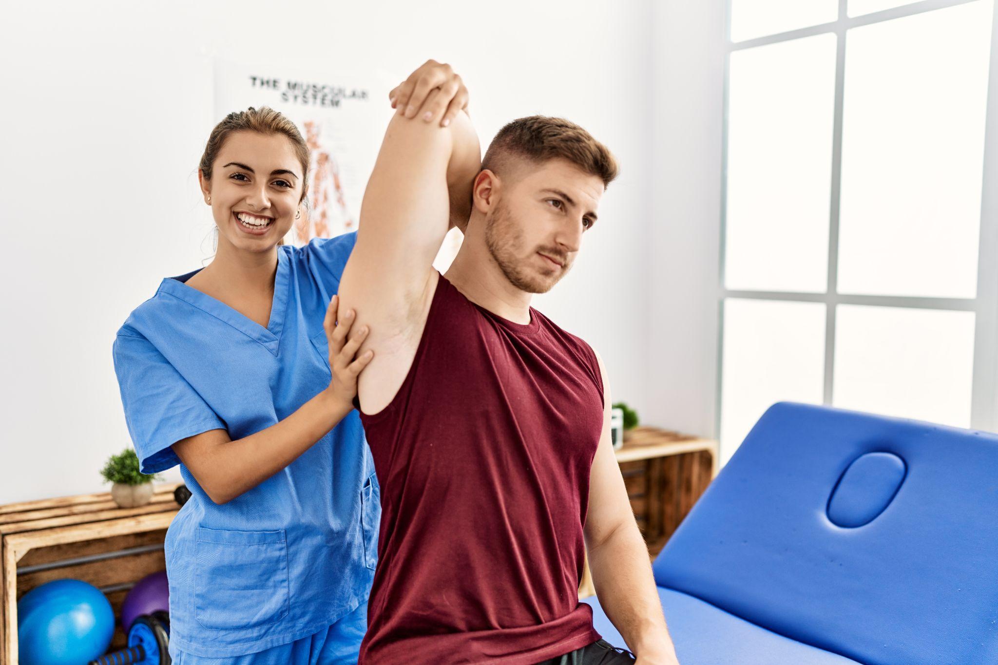 A physiotherapist assists a patient with guided shoulder mobility exercises during rehabilitation. The treatment aims to improve joint flexibility and reduce stiffness after injury.
