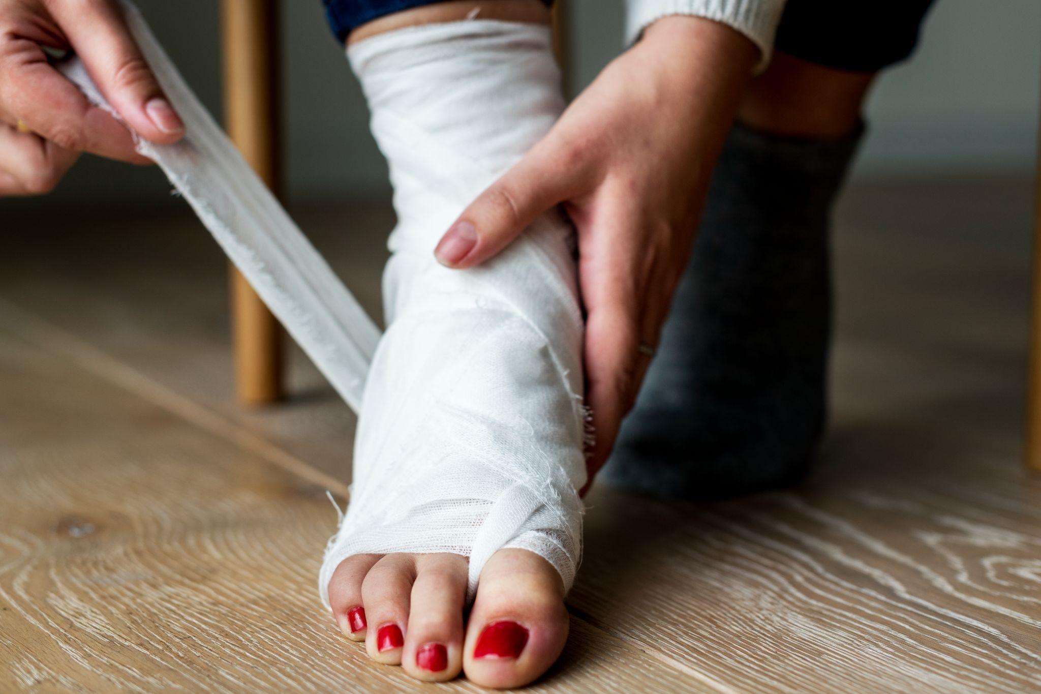 A close-up of a foot wrapped in a medical bandage, highlighting common household injuries that can affect bones and joints.