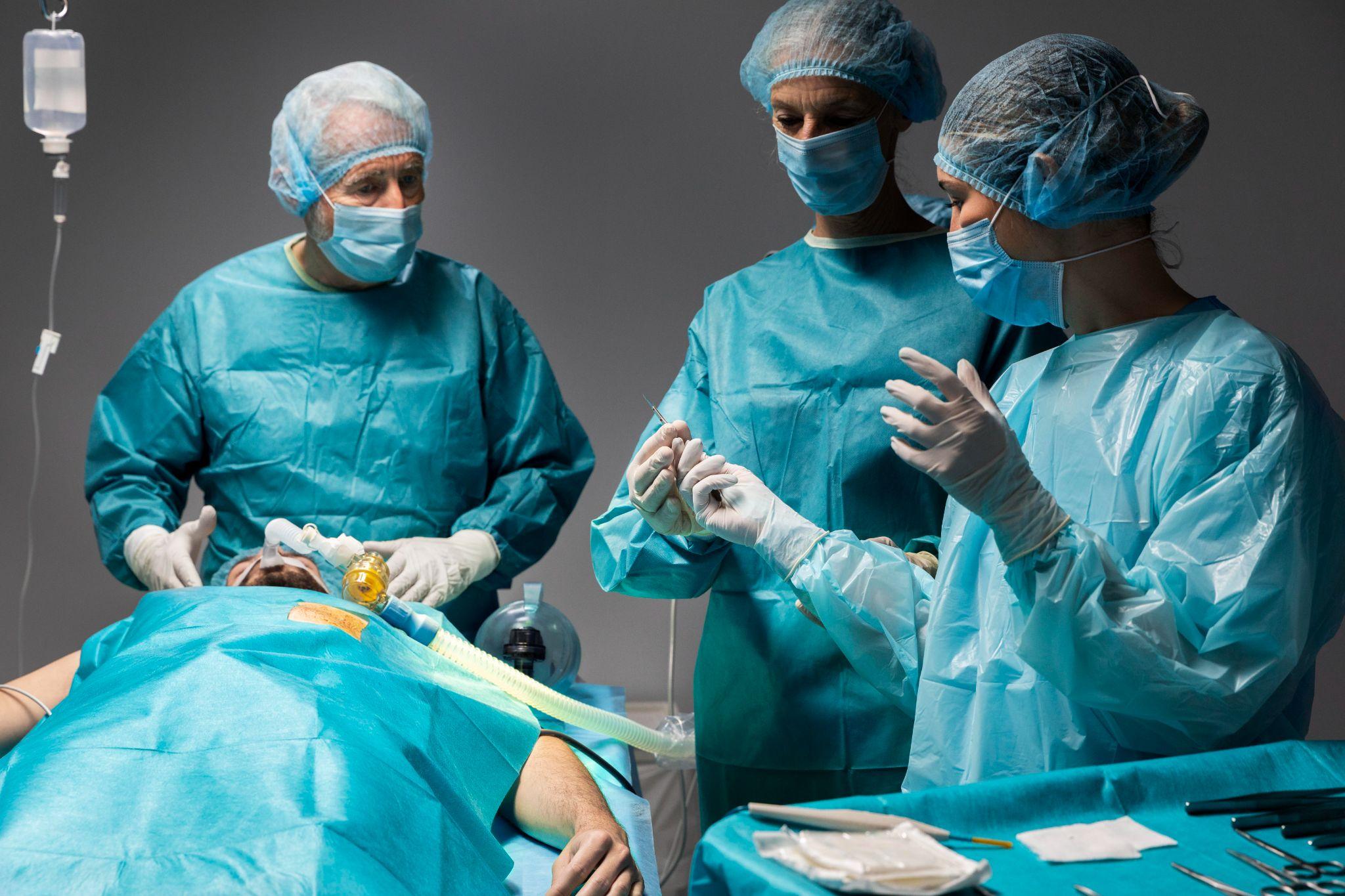 Orthopaedic surgeons performing hip replacement surgery in operation theatre