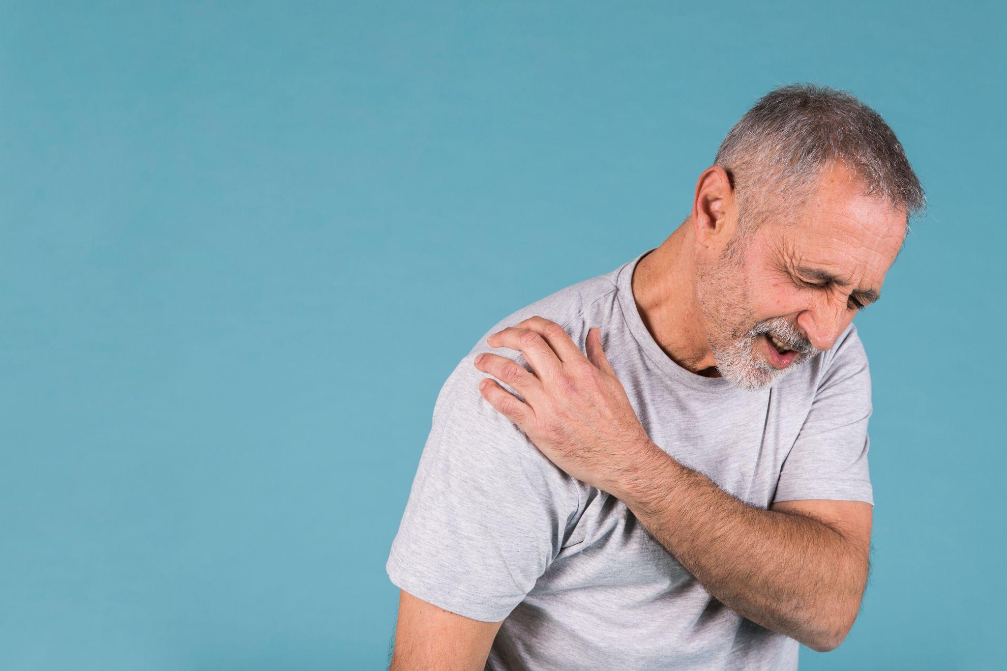 Senior man suffering from chronic shoulder pain possibly caused by shoulder arthritis.