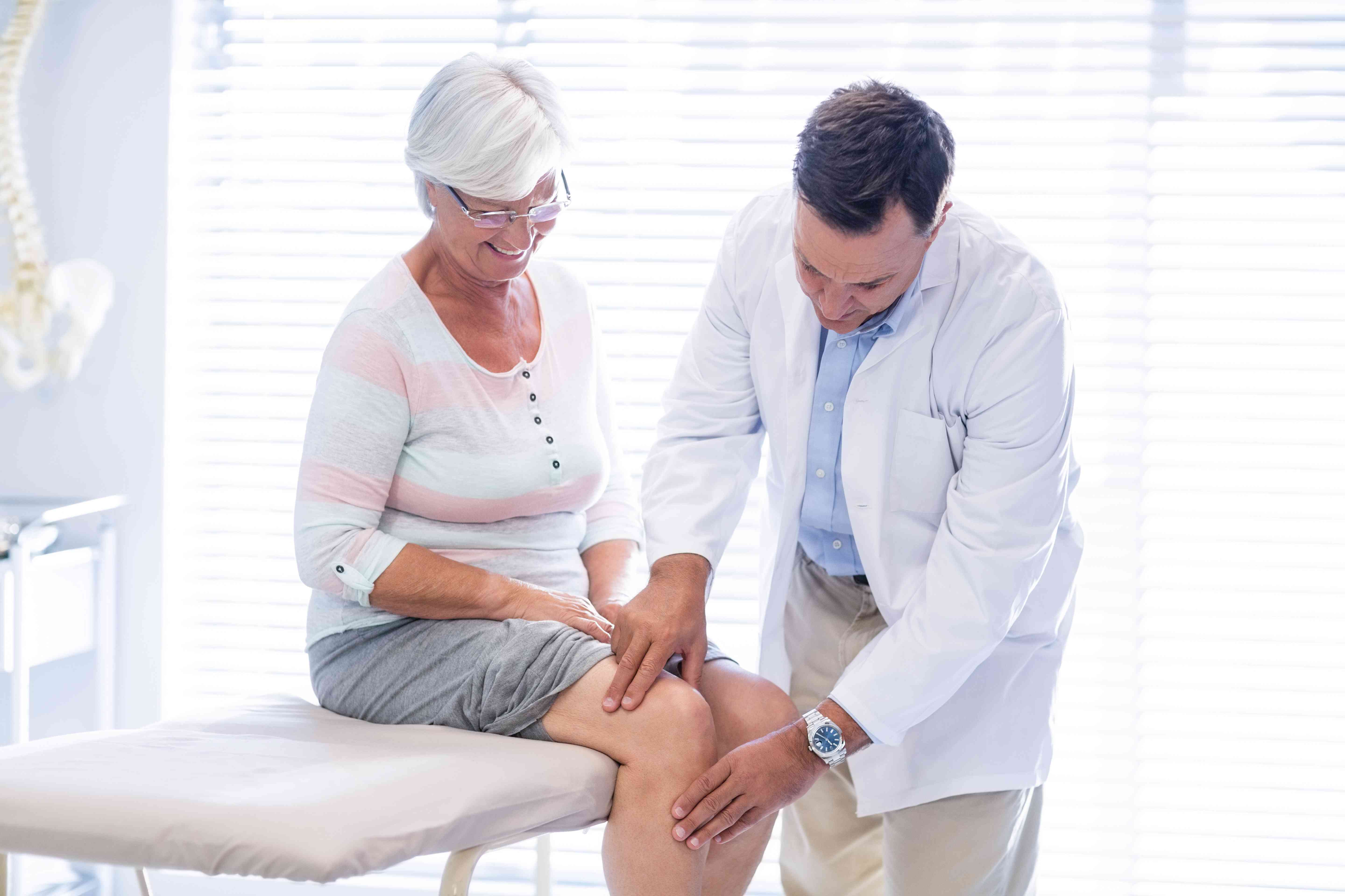 Female patient being examined by a doctor for knee-related issues