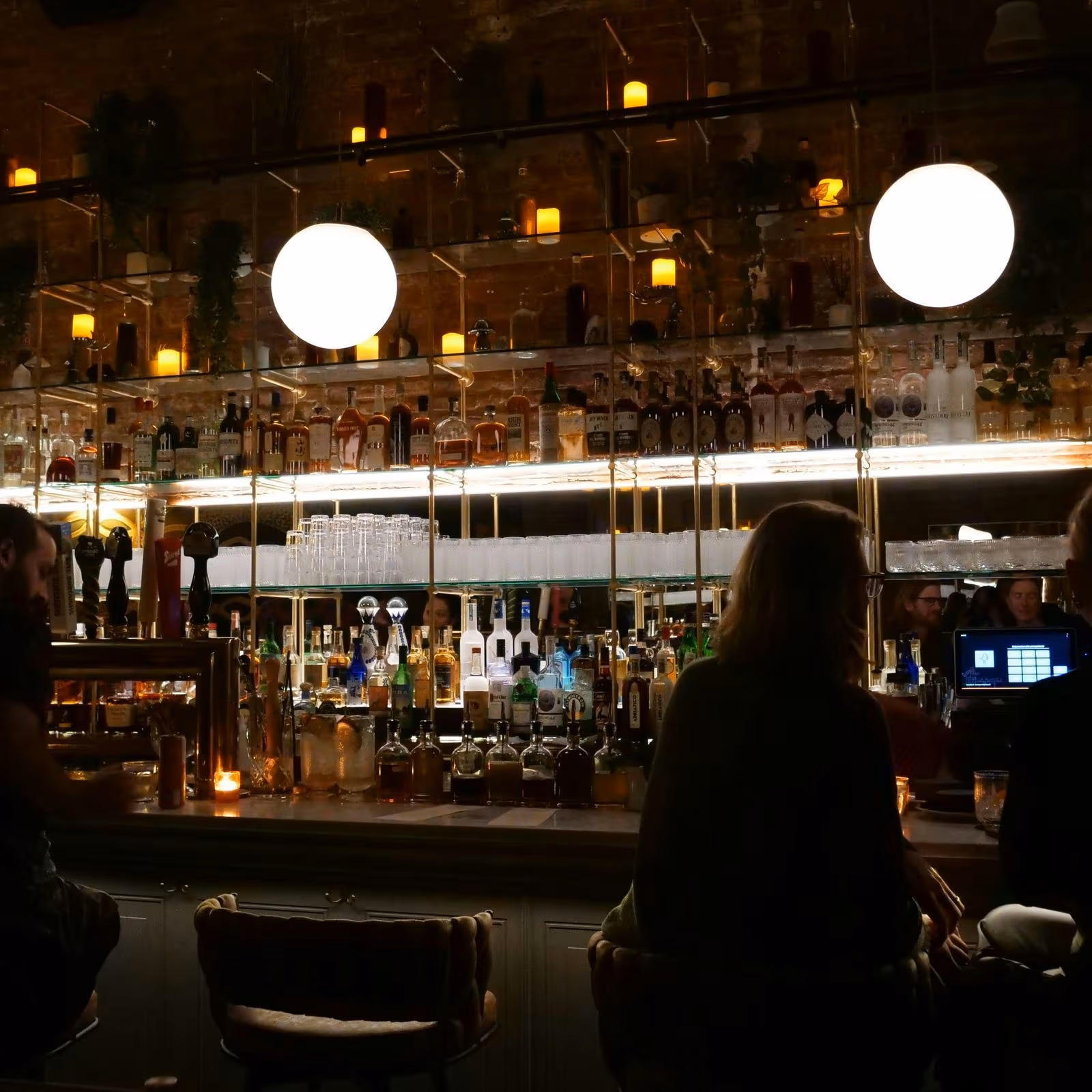 Stylish private room at a New York City bar with cozy lighting and cocktails ; perfect for small parties and events.