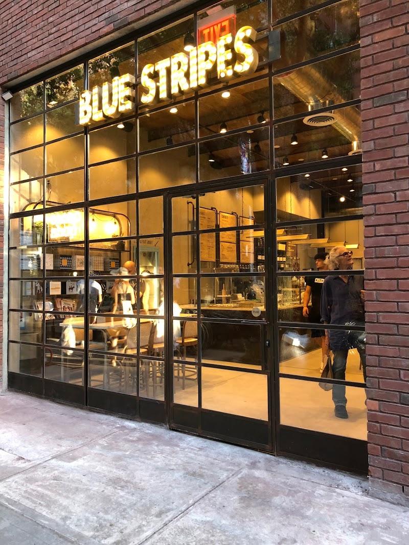 Stripes Wine Bar and Cafe interior with exposed brick walls and warm wood finishes in Greenwich Village