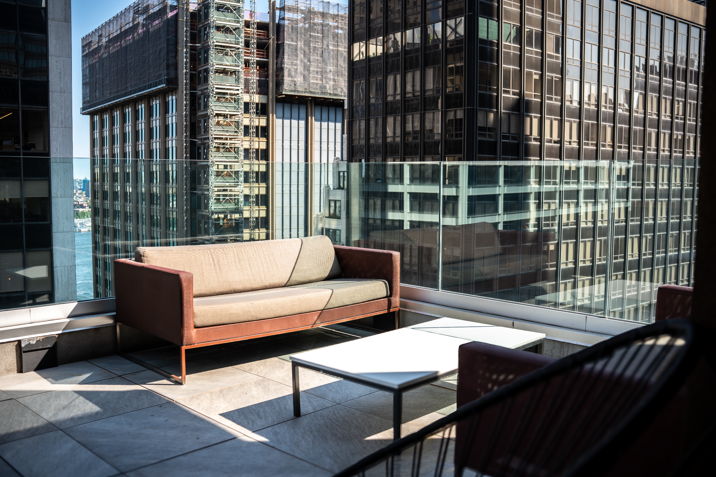 Outdoor patio seating at Highwater Rooftop overlooking Lower Manhattan