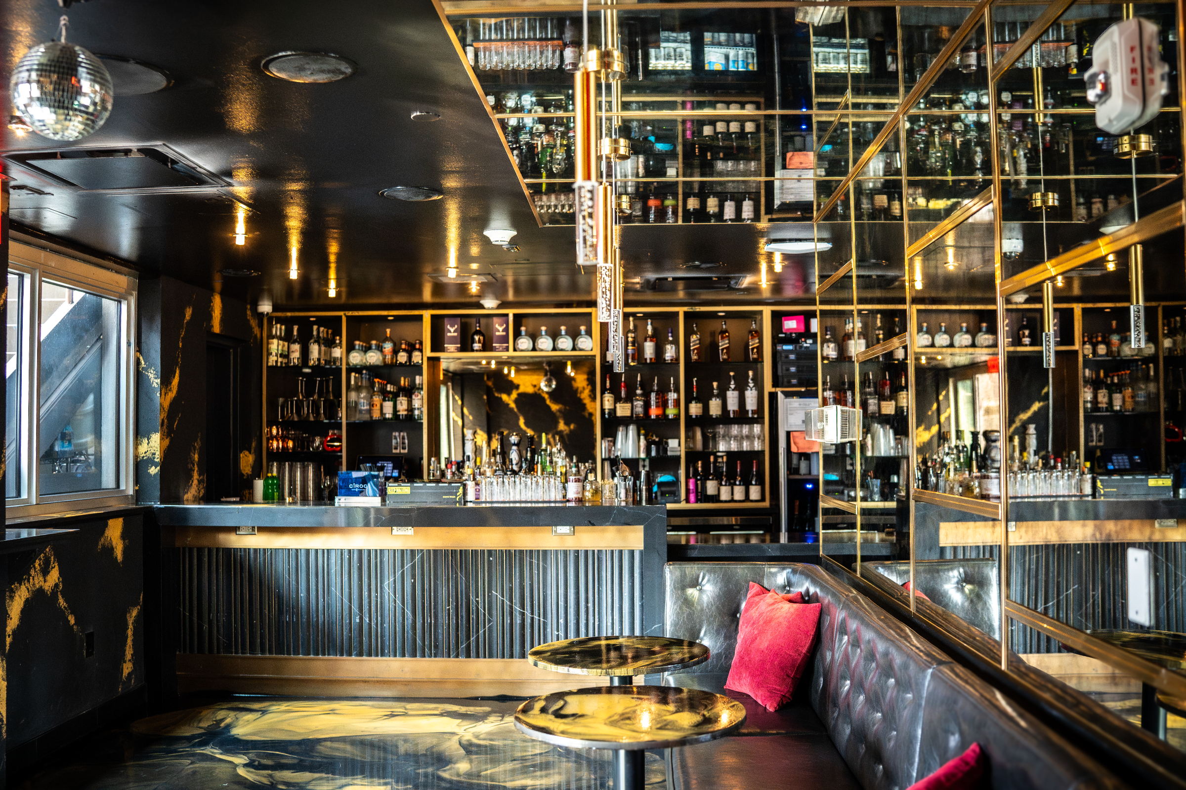 Executive Lounge at Highwater Rooftop with bar, seating, and mirrored wall