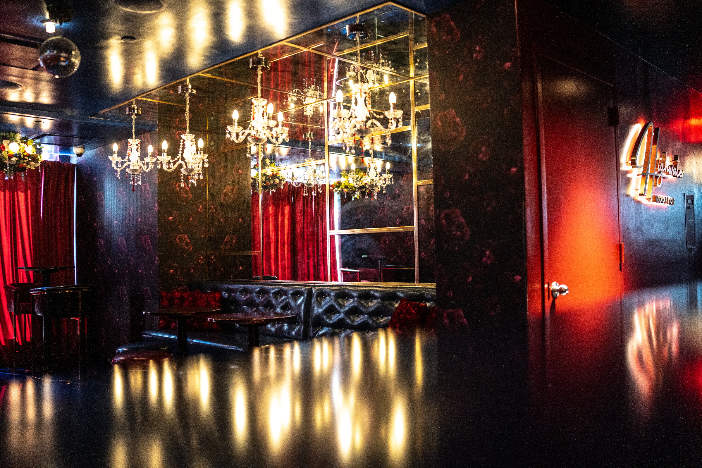 Wide view of the Rose Room at Highwater Rooftop with chandeliers and banquette seating