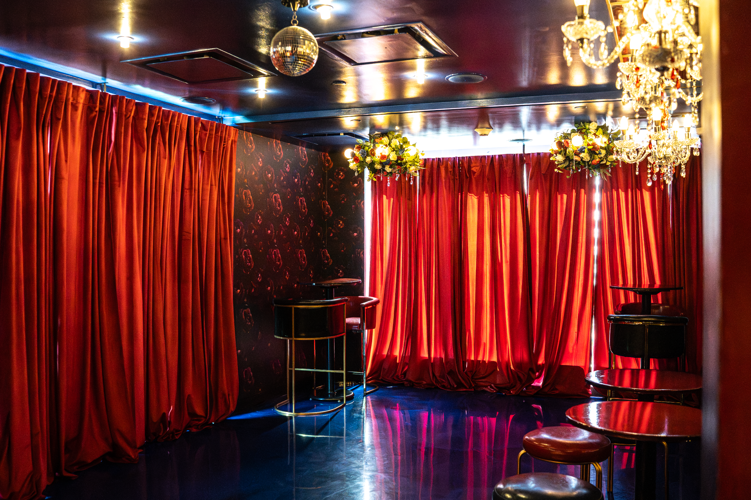 Red-curtained lounge and event area at Highwater Rooftop