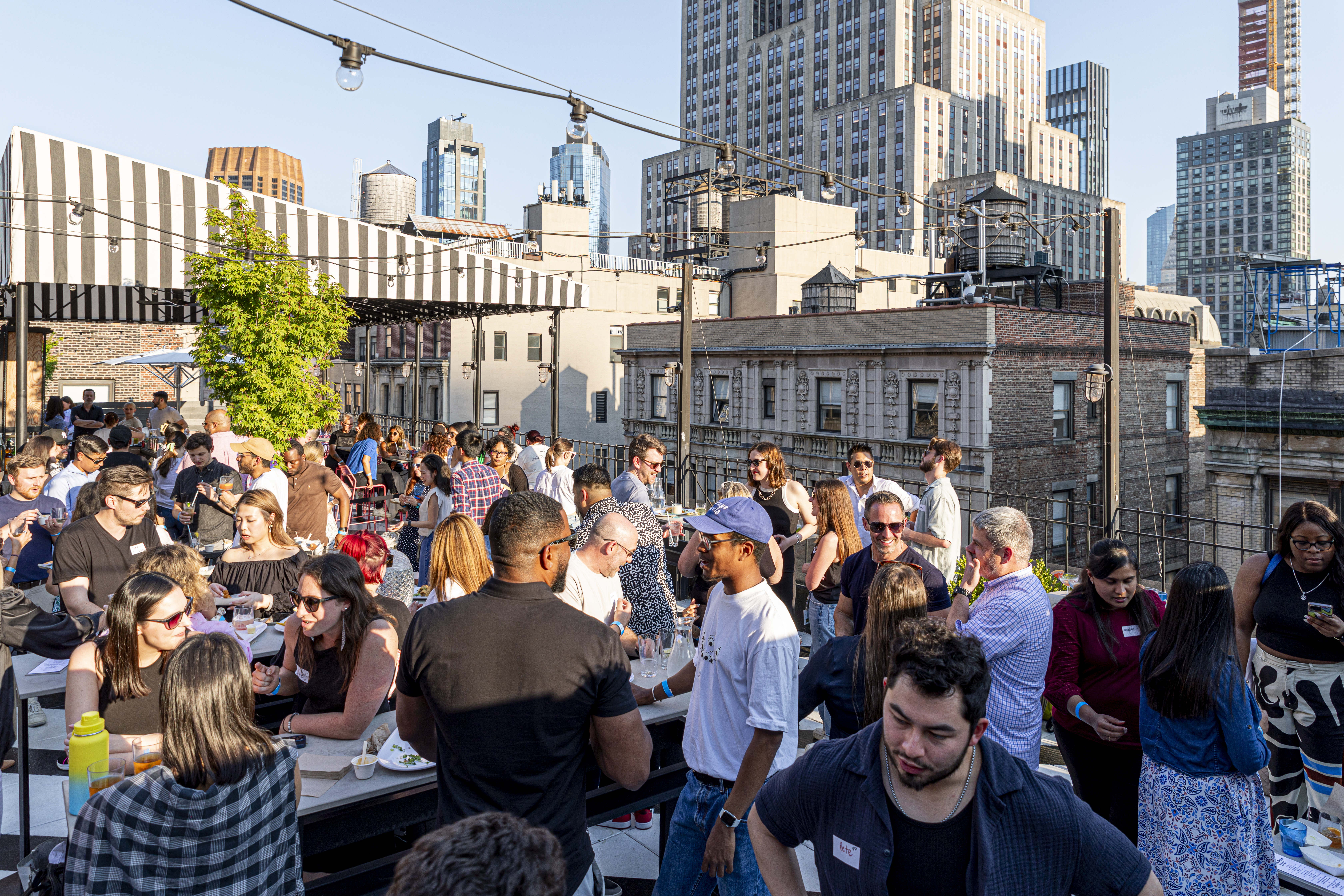 Large rooftop event at Lookup Rooftop with views of Midtown Manhattan.