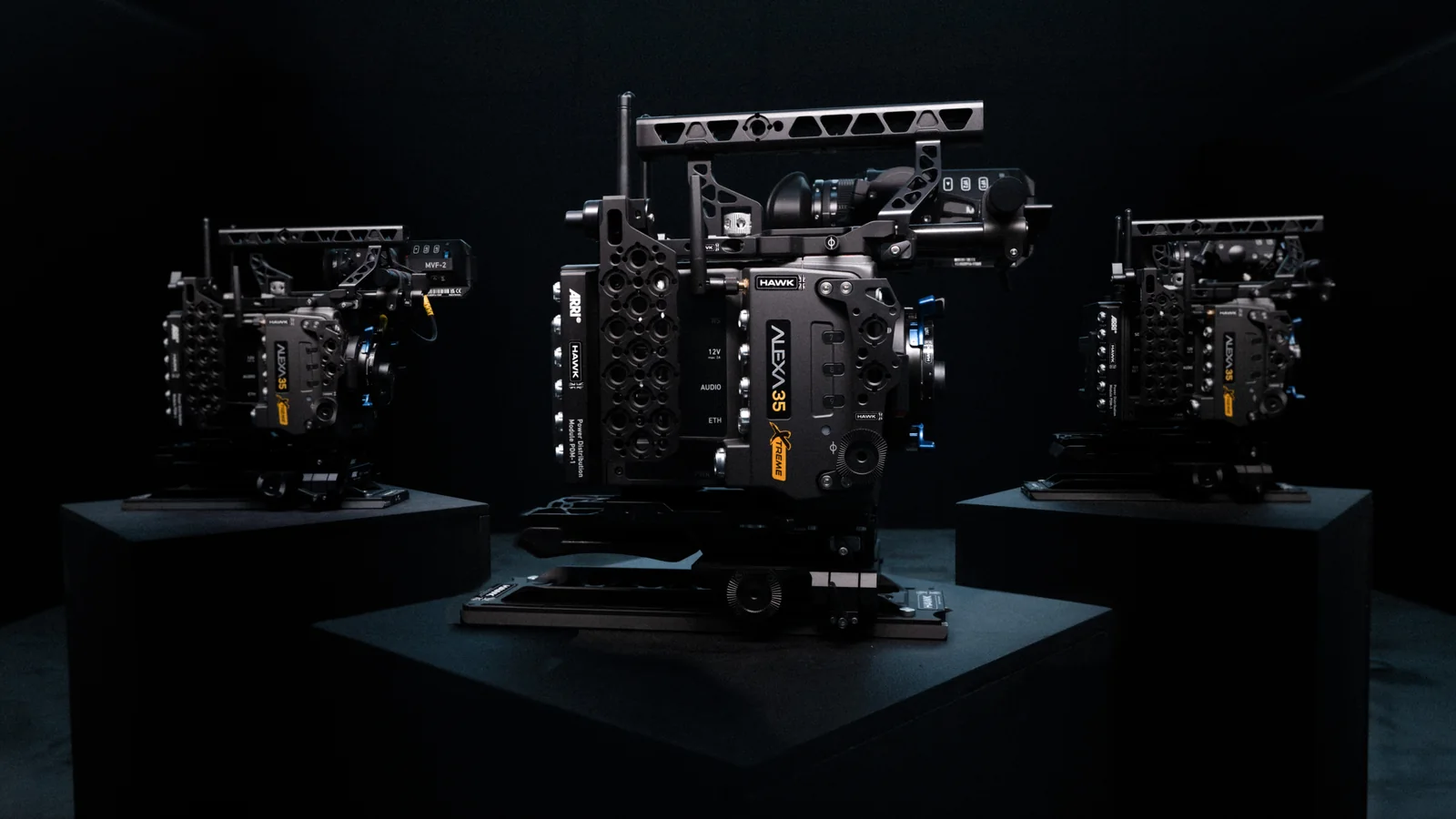 Three ARRI ALEXA 35 Xtreme camera bodies with Hawk-branded rigging displayed on black plinths